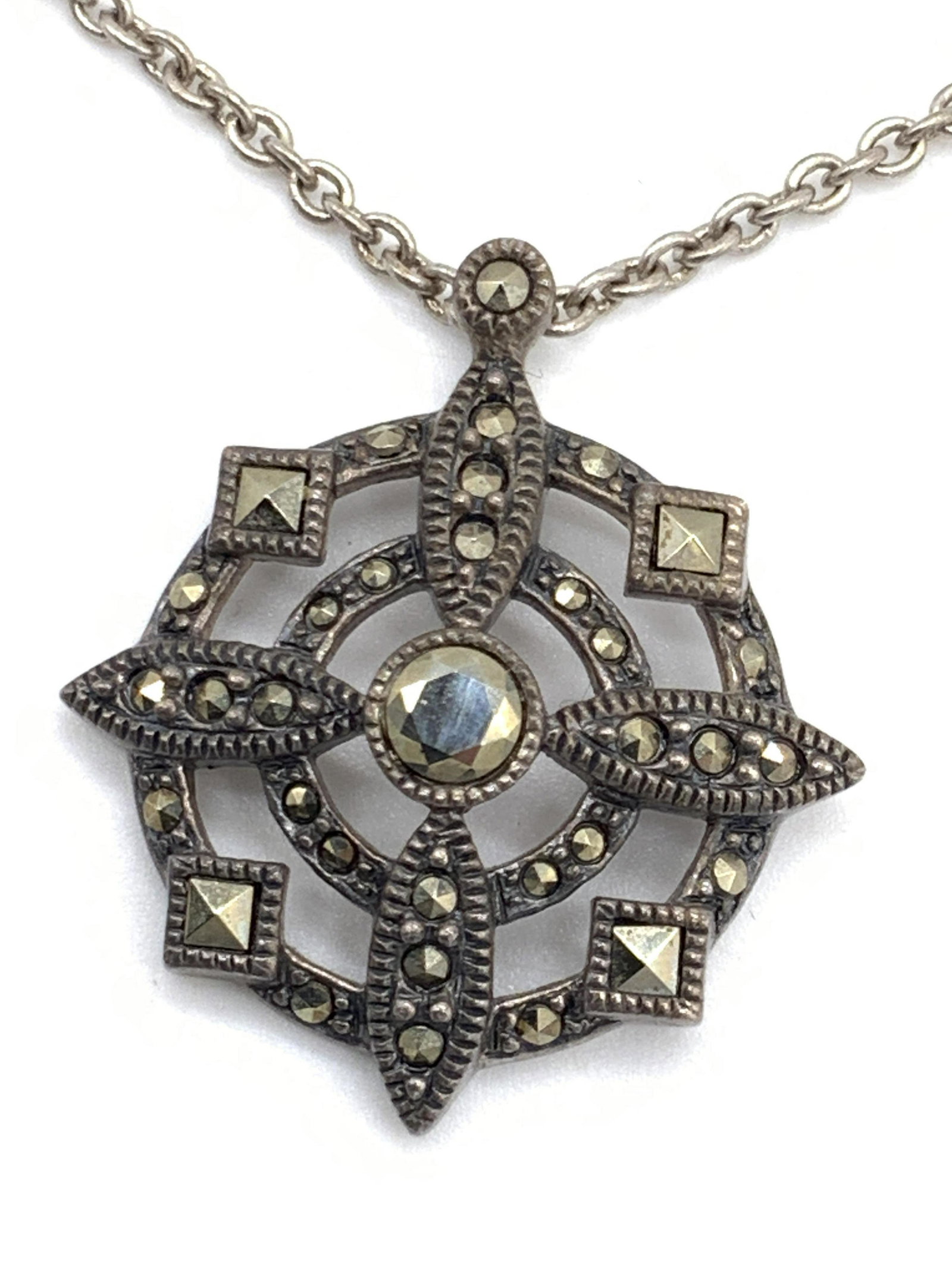 Vintage STERLING SILVER Marcasite Pendant Necklace: A sterling silver necklace chain and pendant, pendant has open metalwork design and is studded with marcasite. Marked 925 on clasp and pendant. Total weight .27 ozt. Necklace length approx 16 in. Pend