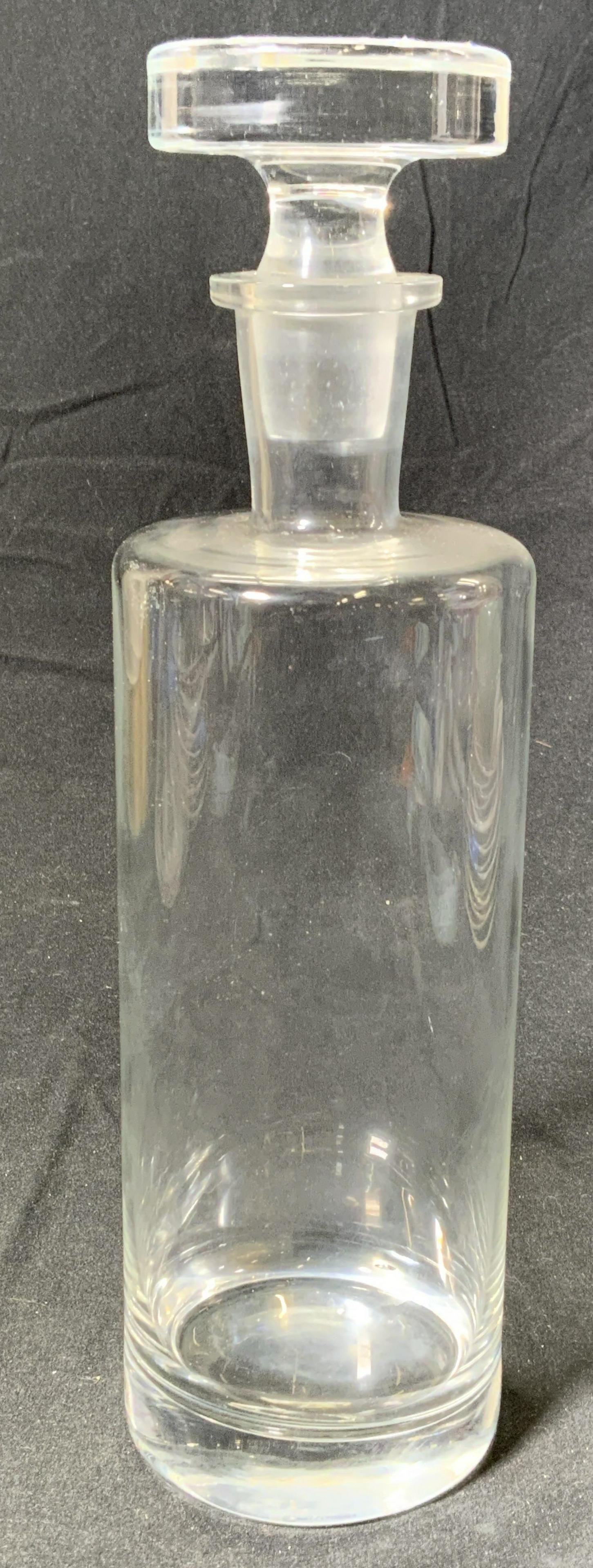 Cylindrical Minimalist Art Glass Decanter: A cylindrical minimalist style art glass decanter. In good condition. Measures approx. 3 inches diameter and 11 inches tall. Property of Manhattan, NY Estate. Decanter, glass decanter, cylinder decant
