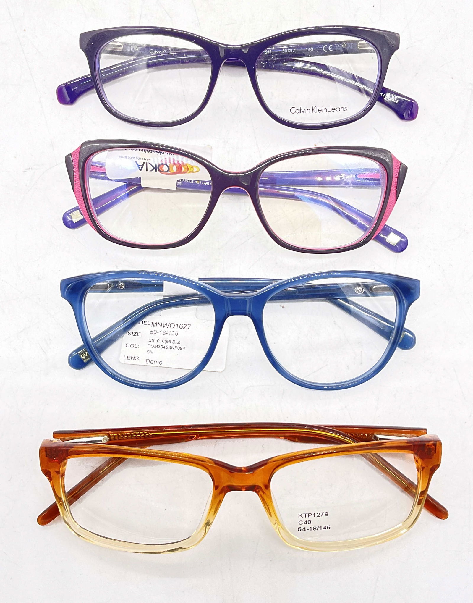 Lot 4 Colorful Eyeglasses, Calvin Klein & More: Lot 4 Eyeglasses. Up cycle to prescription pair of sunglasses or glasses. Surface wear to pieces consistent with age and use. Largest measures, lens 2 inches and ear piece approx 6 inches. Eyeglasses,