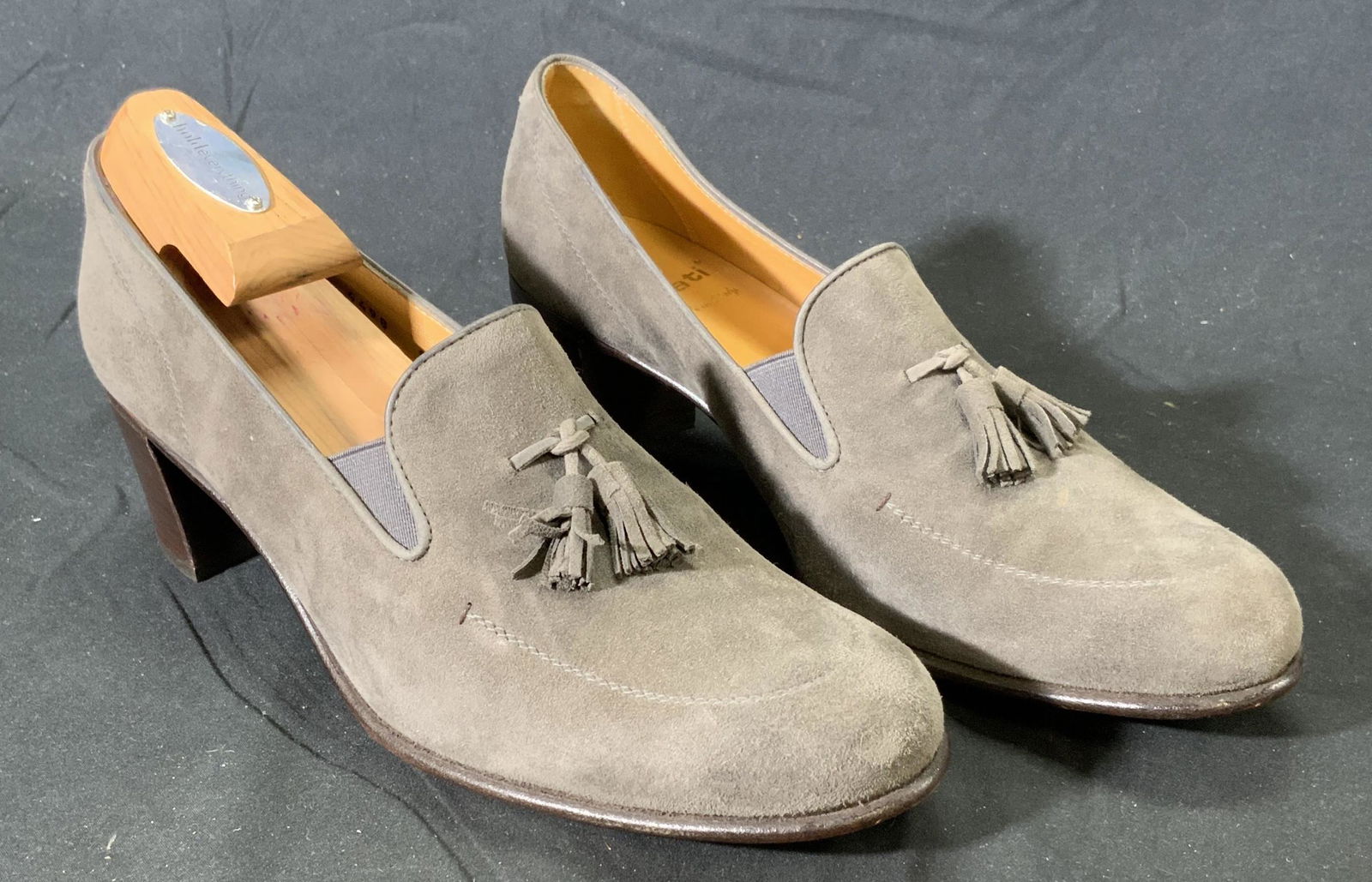 GRAVATI Grey Suede Heeled Loafers: GRAVATI suede loafer with 2.25 inch heel in grey with tassel detail. Size 9.5. Wear consistent with use and exposure. Included Hold Everything shoe tree. Property of Manhattan, NY Estate. GRAVATI, lad