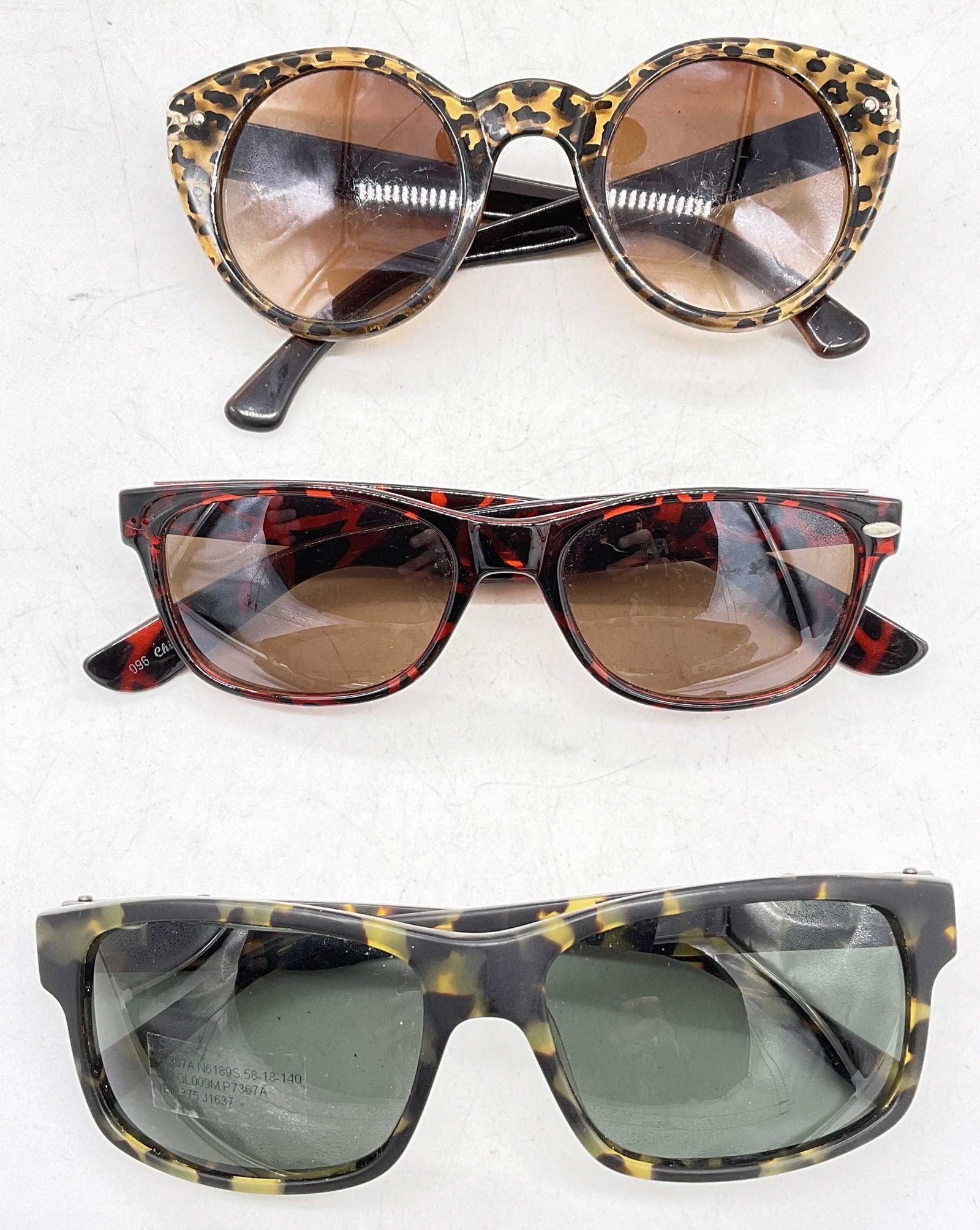 Lot 3 Sunglasses, Nautica & more: Lot 3 Sunglasses. One labeled with Nautica, the others have no mark to them. Up cycle to prescription pair of sunglasses or glasses. Surface wear to pieces consistent with age and use. Largest measure