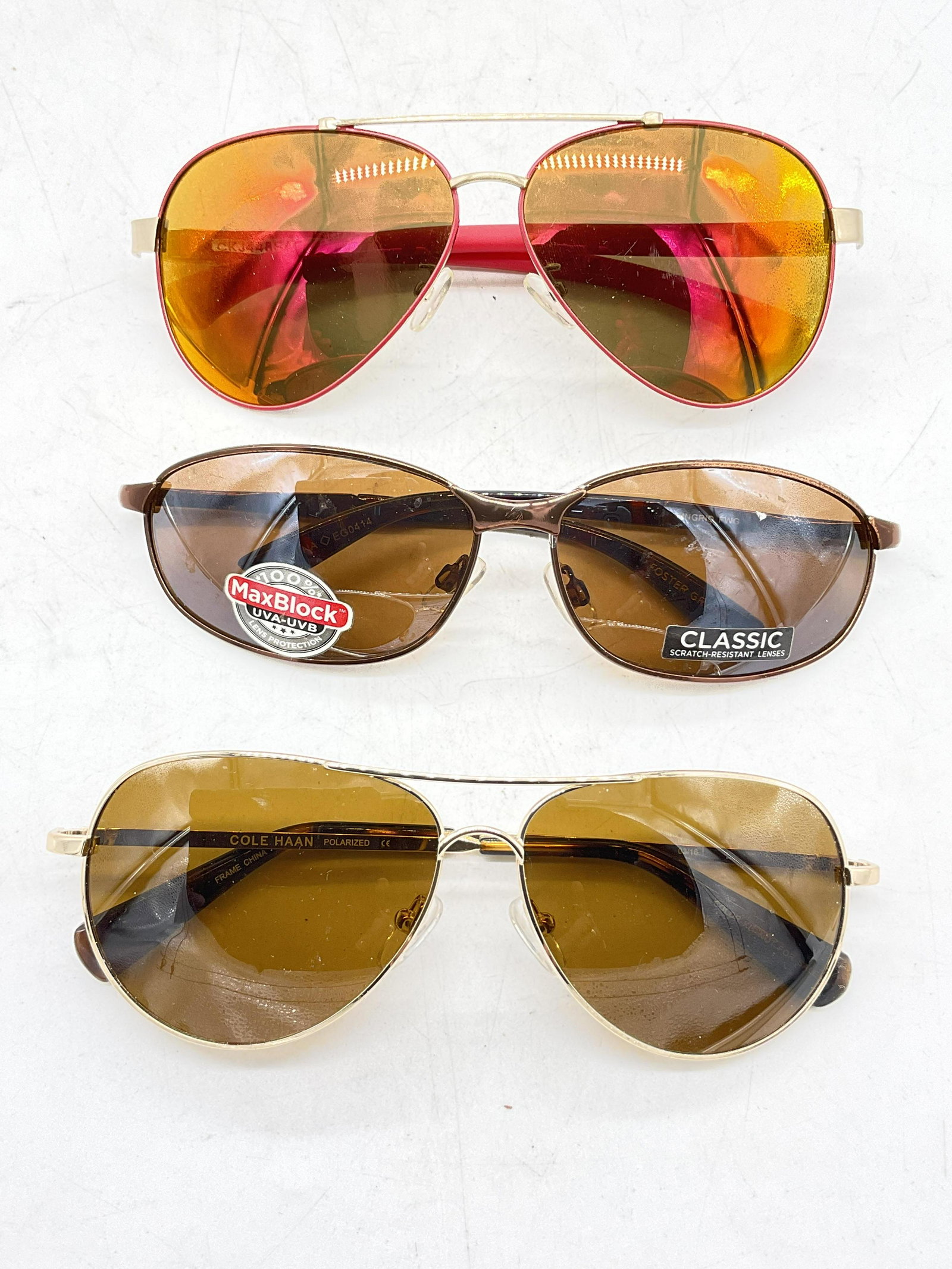Lot 3 Sunglasses, Cole Hahn, Foster Grant, More: Lot 3 Sunglasses. Up cycle to prescription pair of sunglasses or glasses. Surface wear to pieces consistent with age and use. Largest measures, lens 2.5 inches and ear piece approx 6 inches. sunglasse