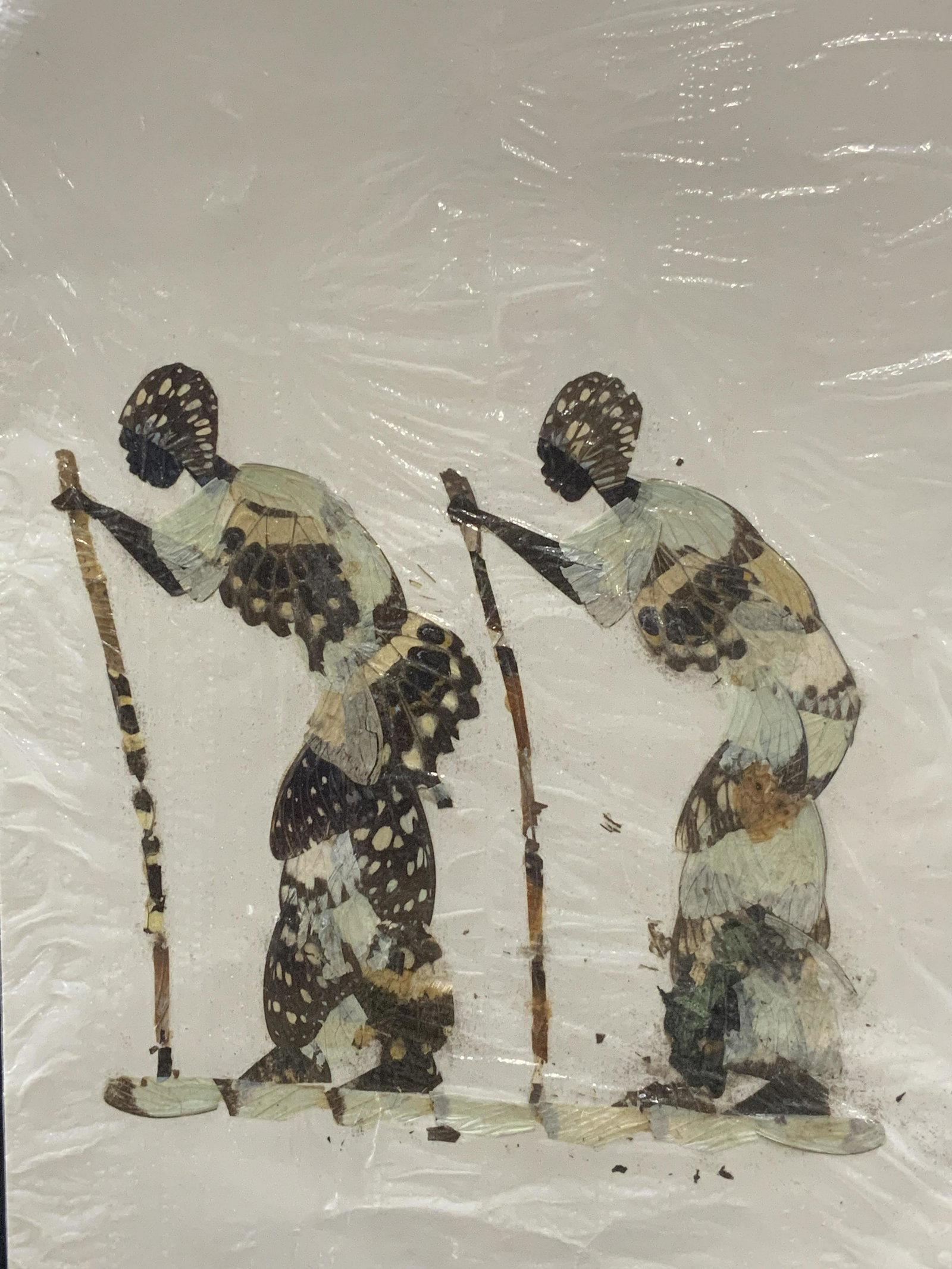Vintage Figural Butterfly Art: Vintage Figural Butterfly Art on paper, wrapped in original packaging, shows two figures with walking sticks, made entirely of butterfly wings, measures approx 15 3/4 x 9 in. Vintage Figural butterfly