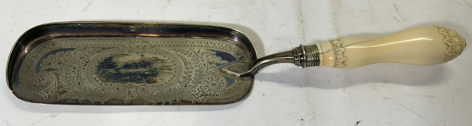 Vintage Victorian Crumb Tray W Handle: Handle attached to tray appears to be carved bone possibly Bakelite. Tray area has intricate etched scrolled, floral, vine & leaf relief detail Piece measures approx 13.5 inches long. Crumb tray, vint
