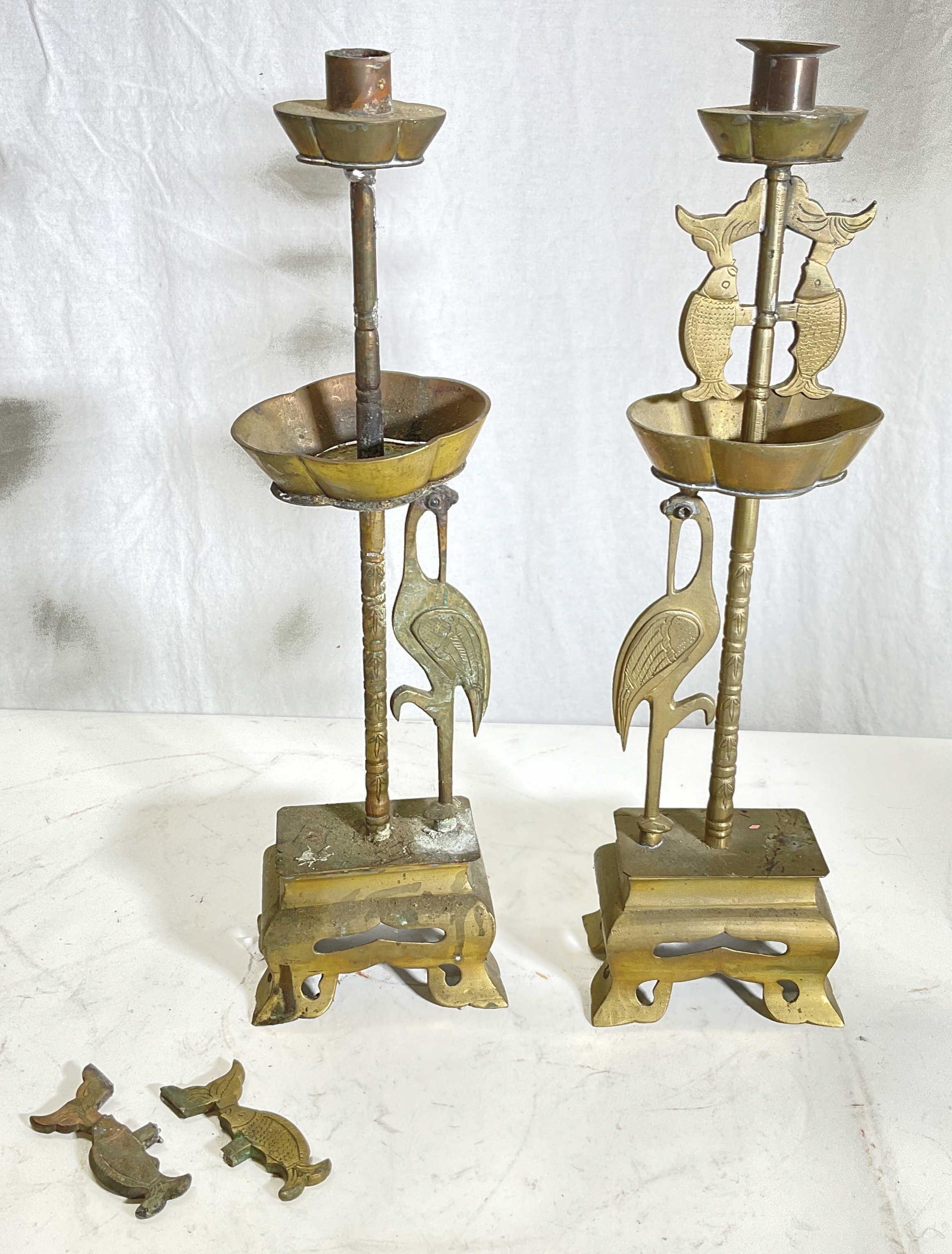 Pair Vintage Brass Candle Holders: Pair of brass candle holders. Cranes to candle holders and fish. Measures approx 15.5H x 4.5W inches. Wear to pieces 1 candle holder is broken. Needs repair. Asian style candle holder, candle holders,