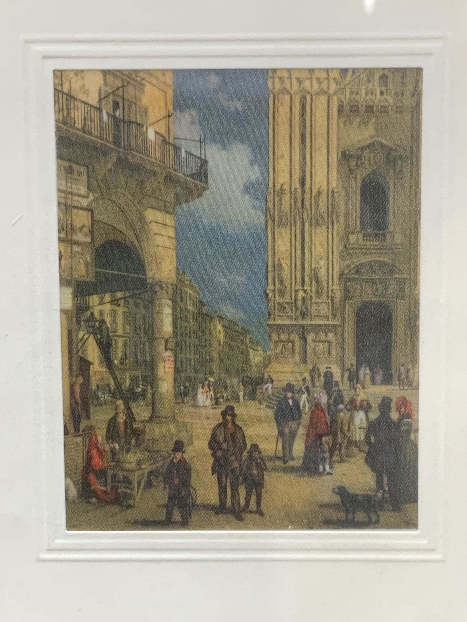 Vintage Italian Offset Lithograph: Vintage Italian Offset Lithograph, subject shows city goers walking through an Italian city square, verso inscribed in Italian, in frame measures approx 8 x 6 in., brown wood frame, surface wear to fr
