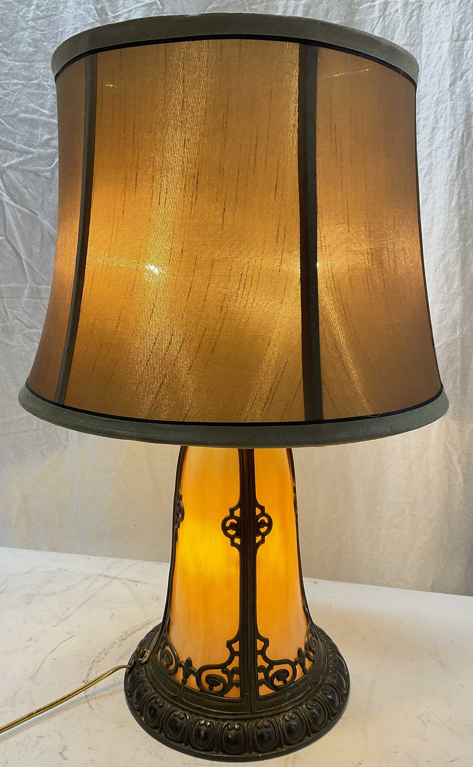 Slag Glass Table Lamp: Slag glass table lamp with Fabric Shade. Base is detailed metal with inserted slag glass. Switch at base of lamp to light up Slag Glass area & pull switch for each individual side to turn on light at 