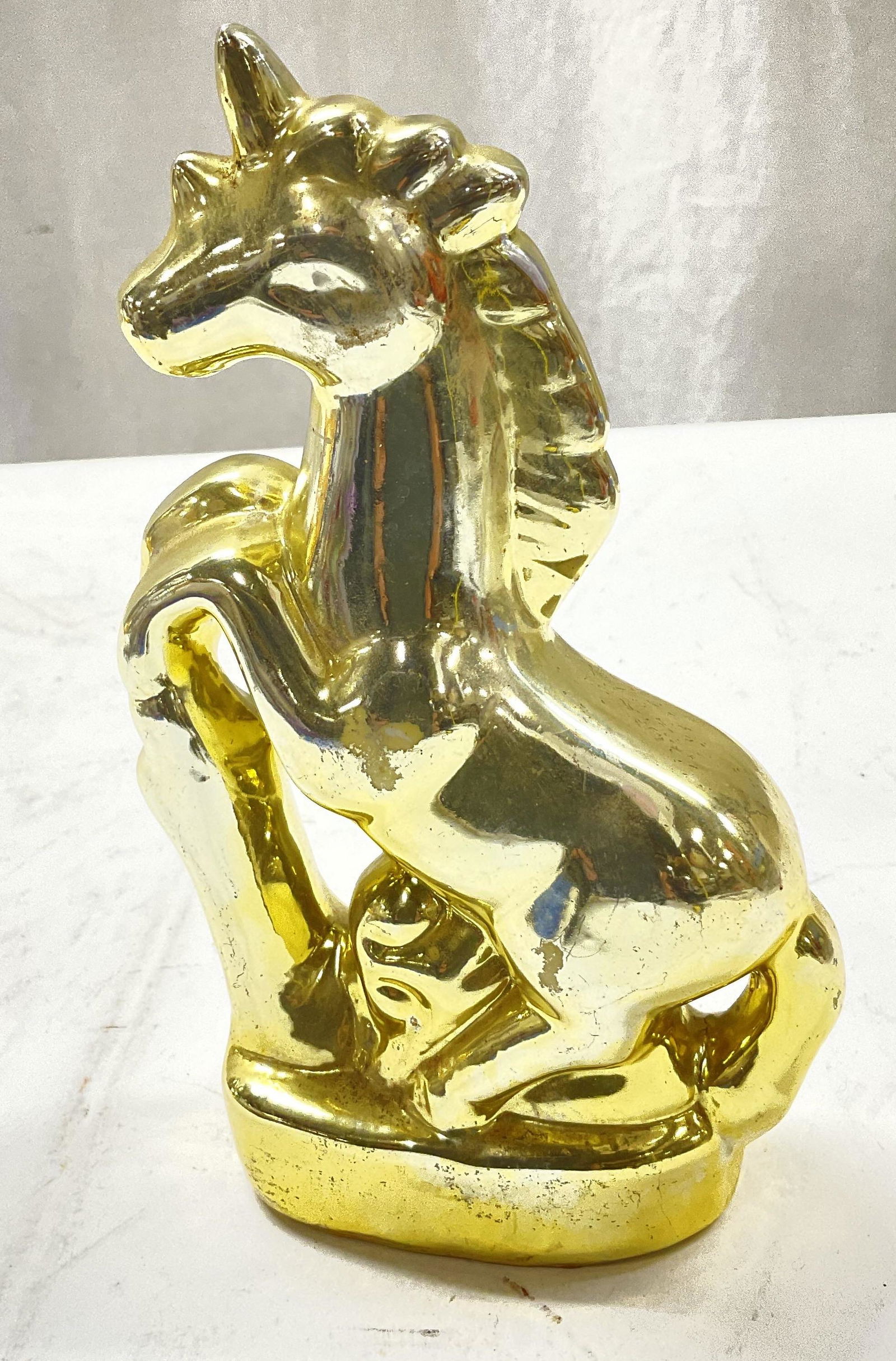 Gold Toned Unicorn Figural: Gold Toned Unicorn Figural. Measures approx 4 x 7.5 inches. Made of glass. Scratches on gold toned surface. Unicorn figural, gold toned unicorn, glass figural, unicorn, decor, unicorn decor, 11