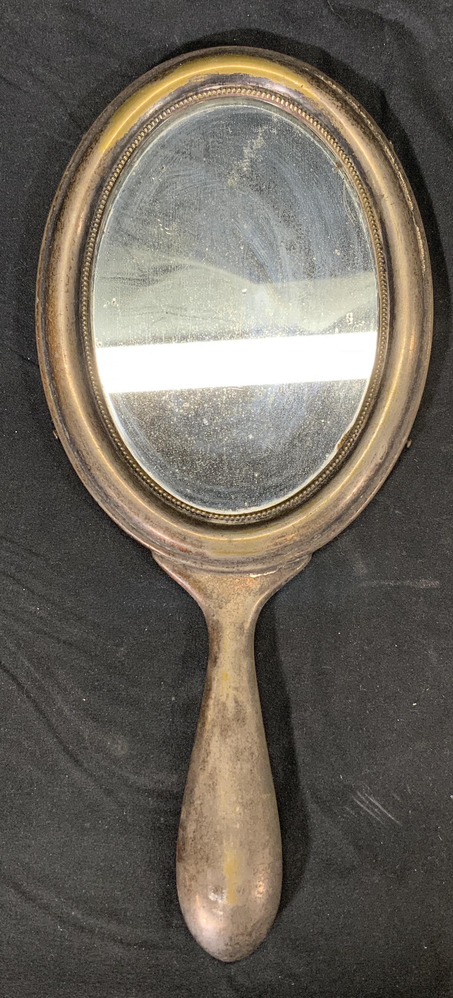 Vintage ARGENTOP Metal Hand Mirror: A vintage metal hand mirror, mark on back appears as ARGENTOP. Possibly silver plated over brass. Condition consistent with age, use, and exposure. Measures approx. 12 x 5.5 inches. Piece is weighted.