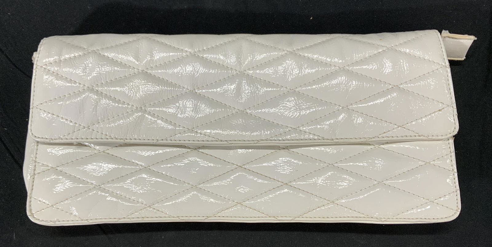 MELIE BIANCO Quilted White Clutch Purse, Vegan: MELIE BIANCO quilted white vegan leather clutch purse. Designer label to interior patch. Snap button closure and one zippered pocket to interior. Some wear consistent with use and exposure. Measures a