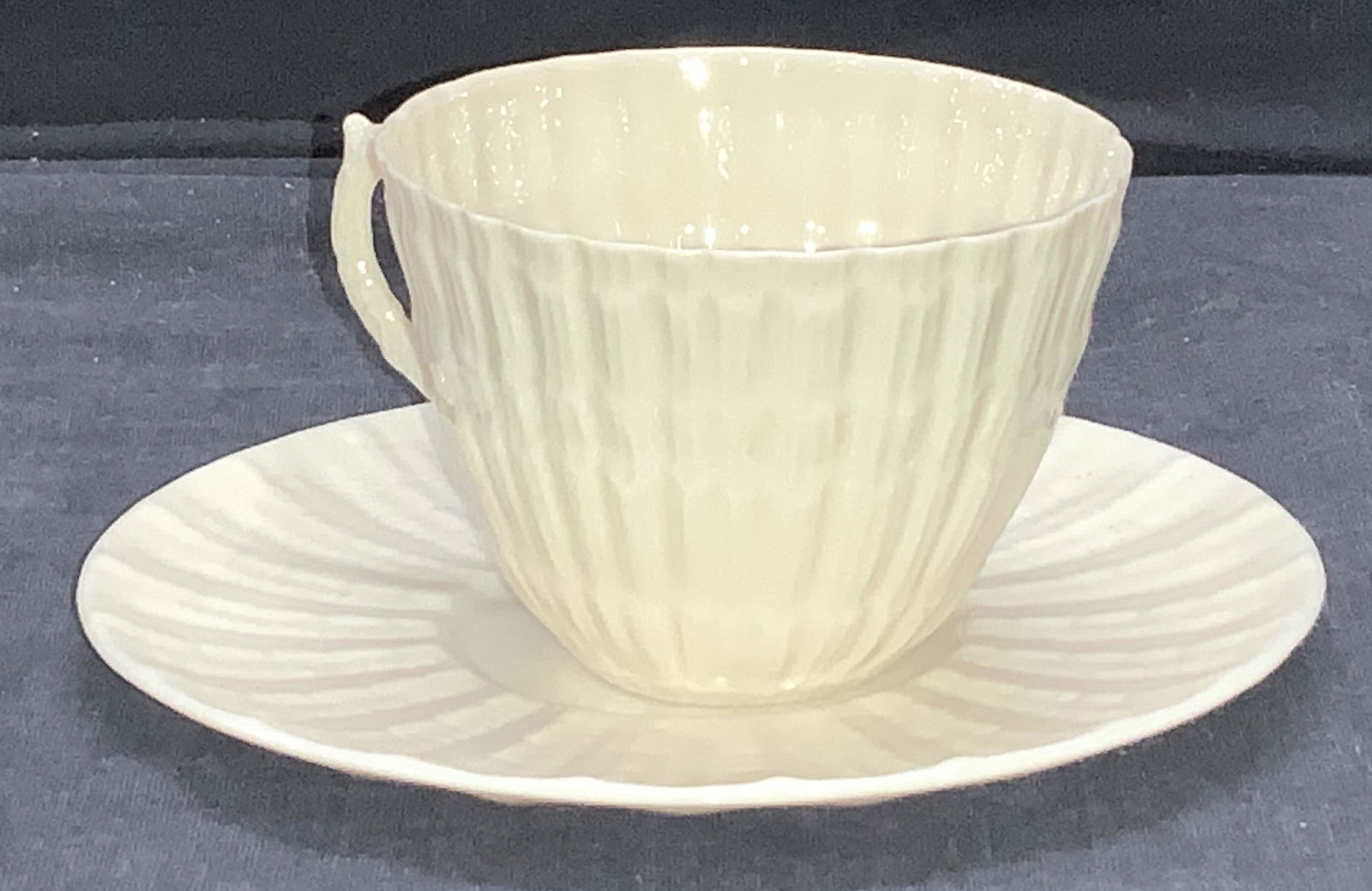 BELLEEk FINE BONE CHINA Tea Cup Saucer, Ireland: Signed Vintage Fine Bone China Cup and Saucer, Belleek, made in Ireland, Ireland’s most sought after chinaware and older manufactored. Saucer 5.5 in. Cup 2.5 in. Ht. In cream toned porcelain with em
