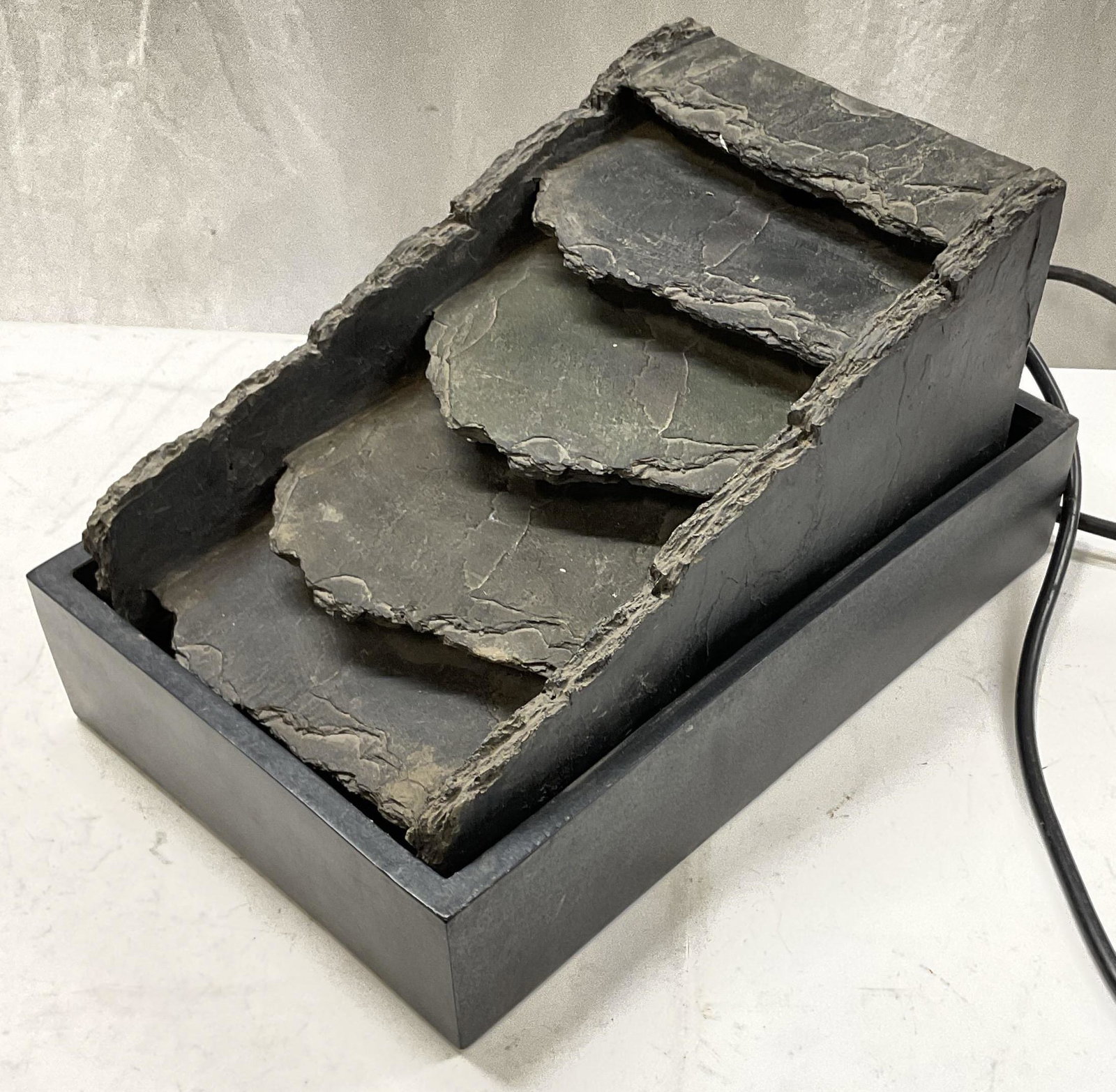 Sloped Table Top Water Fountain: Sloped Table top water fountain. Weight to piece. Inner piece comes out of base. Measures approx 14 x 8 x 9 inches. Not tested for functionality. Surface wear consistent with age and use. Water founta
