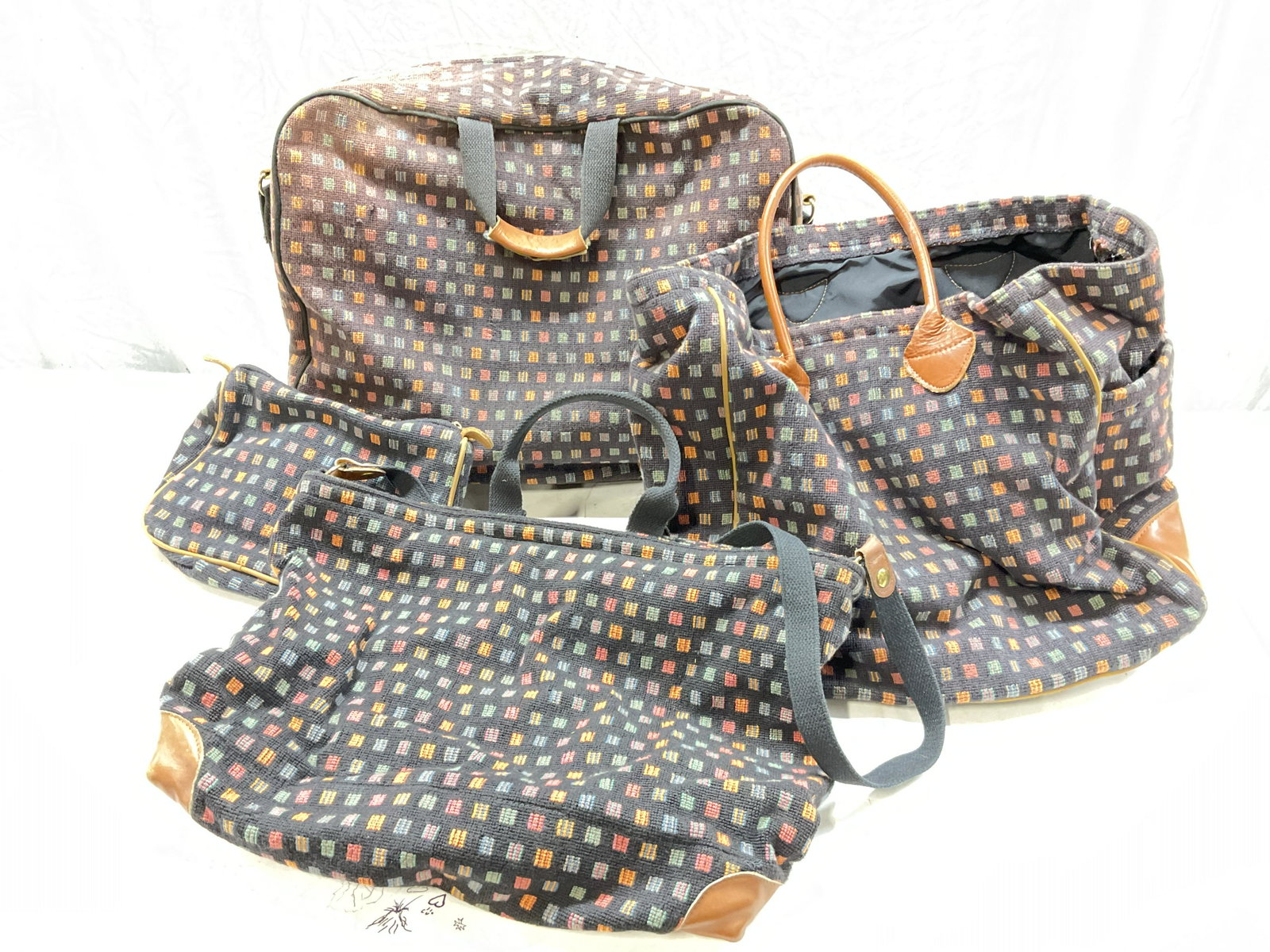 Set of American Collection Stitched Travel Bags: Set of The American Collection Stitched Travel Bags. Largest bag measures approx 20 x 17.5 inches. Surface wear to pieces consistent with age and use. Straps to 3 pieces. 1 is a toiletry bag. Zippers 