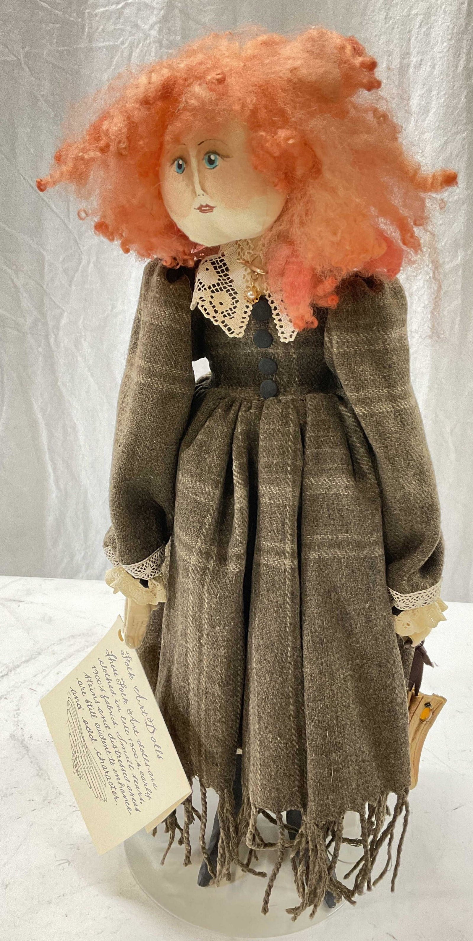 Curly Red Haired Folk Art Doll W Stand: Curly red headed folk art doll. Hand made from recycled textiles from 1800 -1900s. Doll has stand. Measures Approx 17 x 6 inches. Surface wear consistent with age and use of doll. Doll, red hair doll,