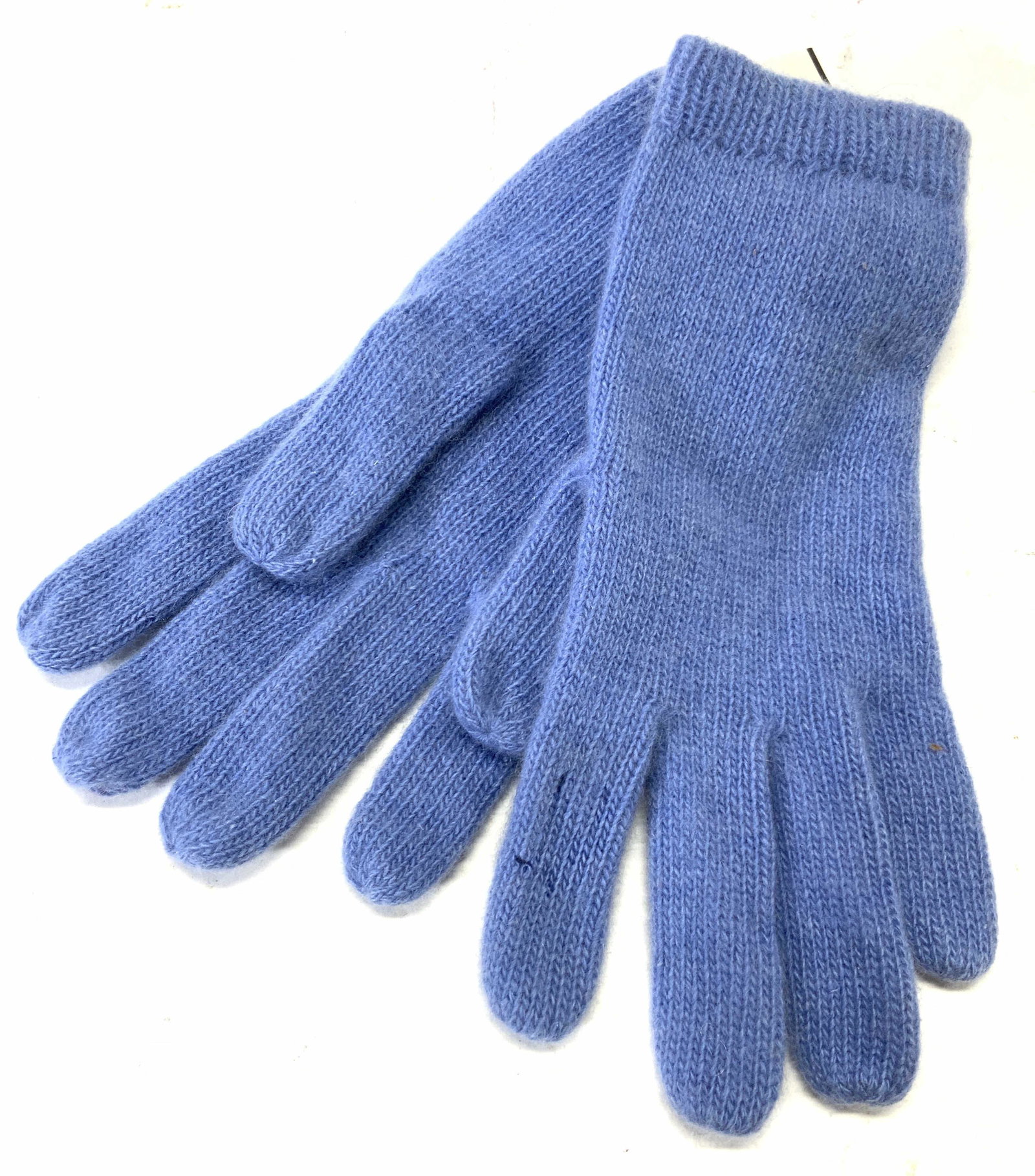 Century 21 100% Cashmere Knitted Gloves: Pair of blue toned knitted gloves with tags. Tags reads 100% cashmere and Century 21. Approximately 8.25 inches long. Evident holes to index fingers. Century 21 cashmere gloves, knitted gloves, winter