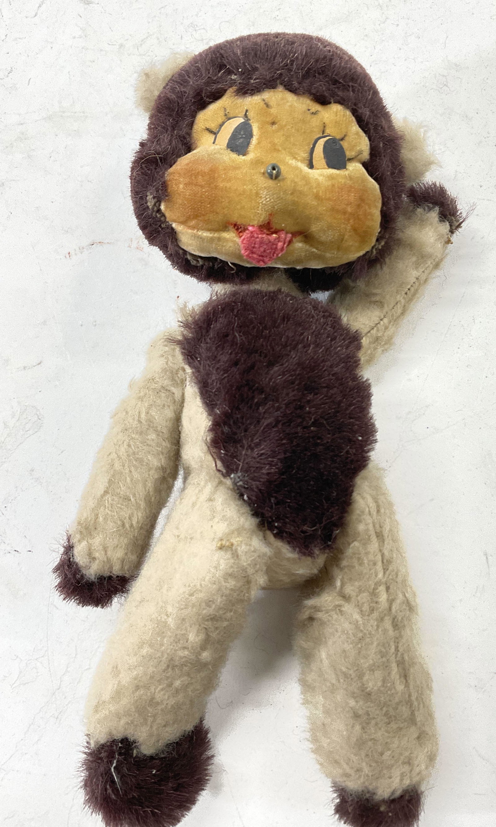 Antique Stuffed Doll: Vintage, possibly antique stuffed doll, reminiscent of a monkey. Measures approx 10 x 4 inches. Surface wear consistent with age. Fabric is worn. Monkey doll, antique doll, vintage doll, stuff doll, c