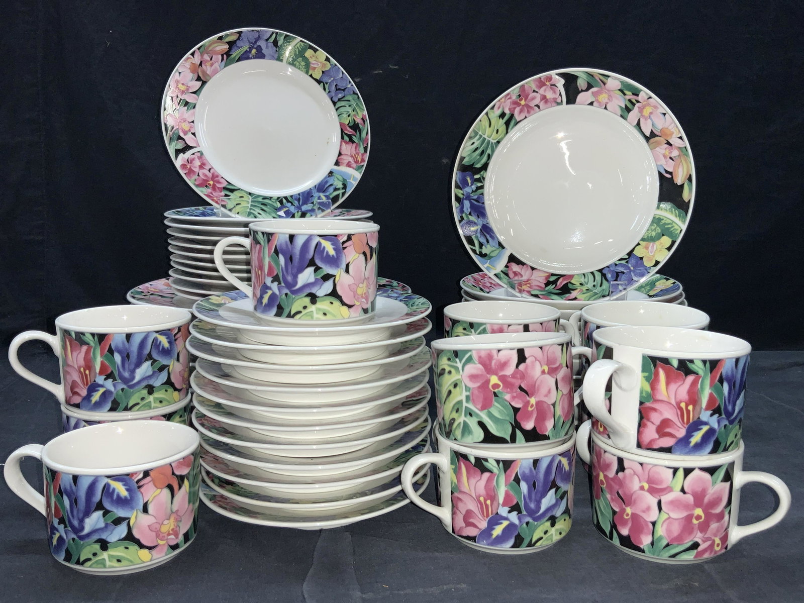 LYNNS 54 Stoneware Dish Set: A dish set consisting of 54 PCs, all pieces are white stoneware with floral bands along the center from that depicts colorful floral patterns. 12 coffee cups, approximately 2.25 inches tall and 3.25 i