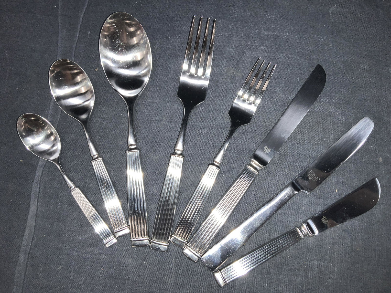 DANSK 162 Silverware Set: A set of Utensils consisting of, 26 dinner forks, approximately 7.25 inches long. 23 dessert forks, approximately 7 inches long. 23 Dinning spoons, approximately 7.25 inches long. 22 butter knives, al