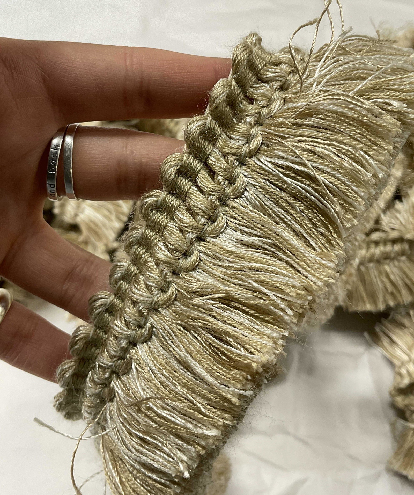 Neutral Upholstery Trim Tassel Accessory: Neutral Upholstery Tassel Accessory. Upcycle for curtains, furniture, pillows, & more. 3 separate lengths. Longest measures approx 150 inches. Small 25 in piece attached to long tassel. 2 & 3 tassel m