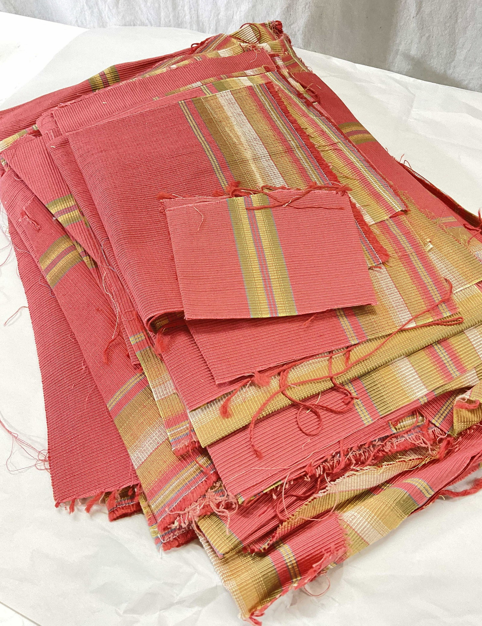 Upholstery Fabric Pieces / Accessory: Pieces of all different sizes of the same patterned fabric. Salmon colored and detailed with earth toned stripes. Up cycle for upholstery, pillows, curtains, & home decor. One large piece measures 56 