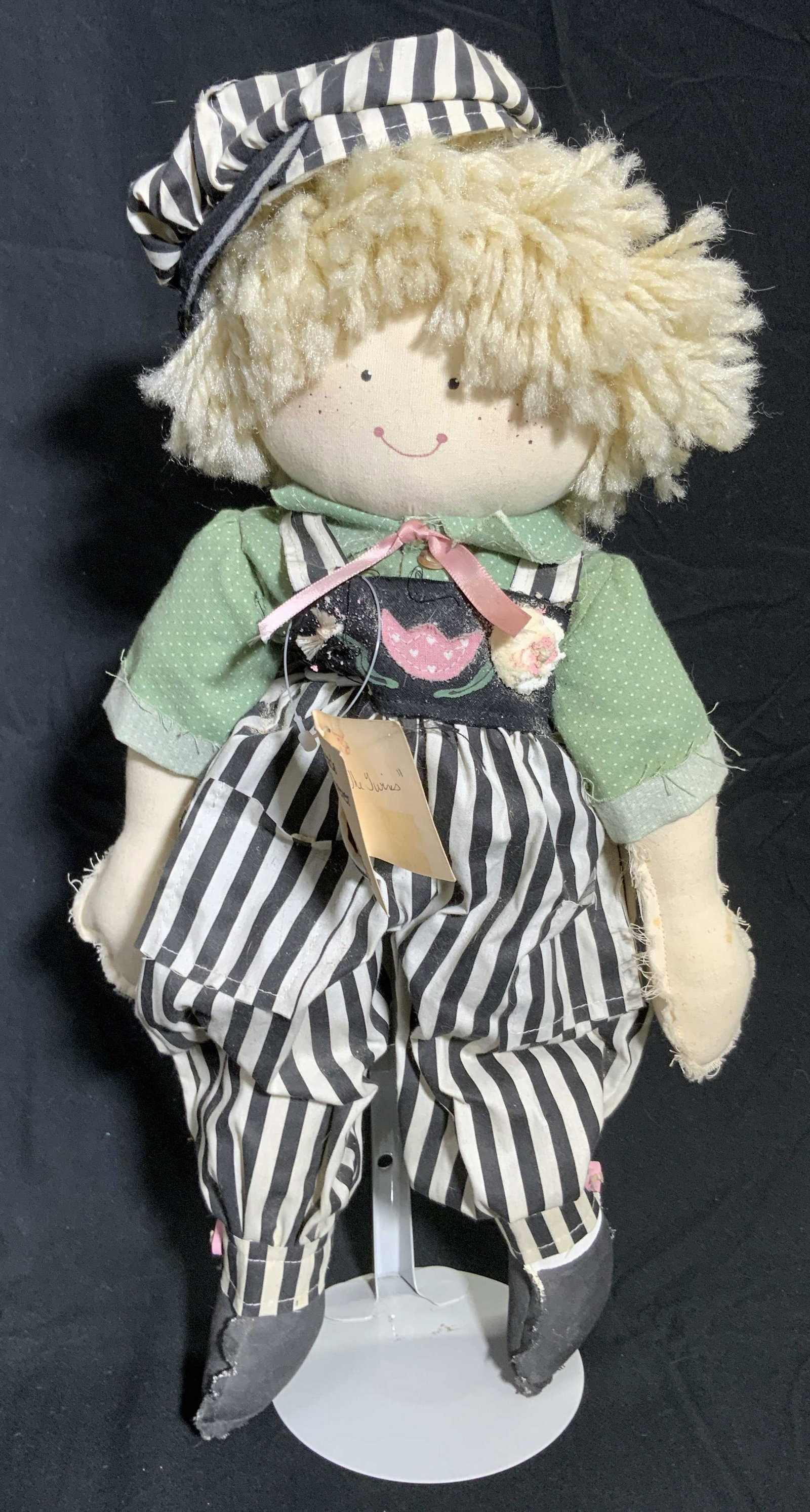 FRIENDS FORVER MARY LYKINS Fabric Doll W/ Org Tag: A stuffed fabric doll wearing striped and Polk dotted clothing. Tag reads FRIENDS FORVER MARY LYKINS. Measures approx 17H x 10W in. Measured at widest point. Measured on stand. Some losses to fabric. 