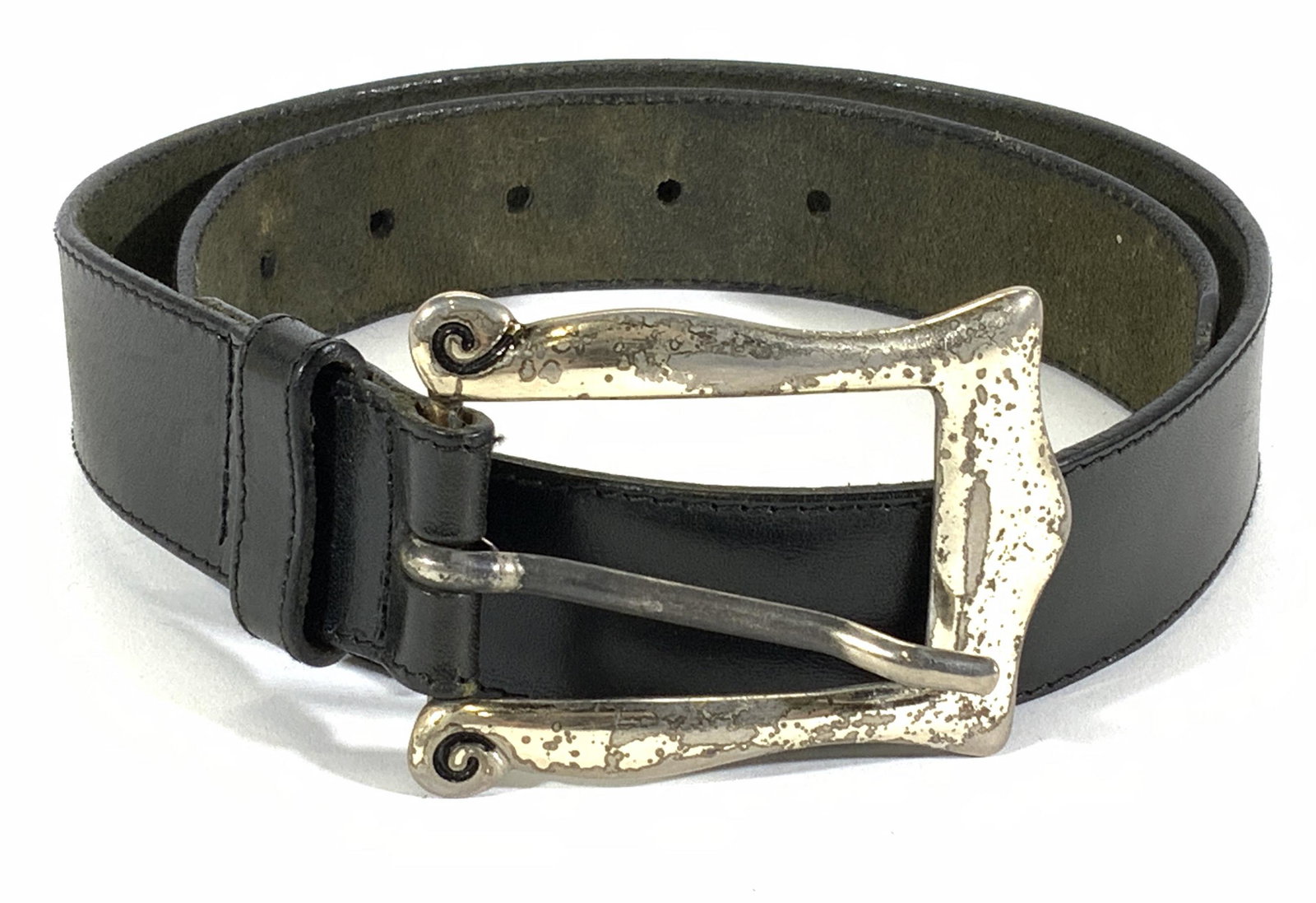 Black Embossed Leather Fashion Belt: Black leather fashion belt with decorative embossed detail. Adjustable waist. Silver tone buckle. Wear to metal consistent with use and exposure. Measures approx. 36.5 inches. Belt, leather belt, blac