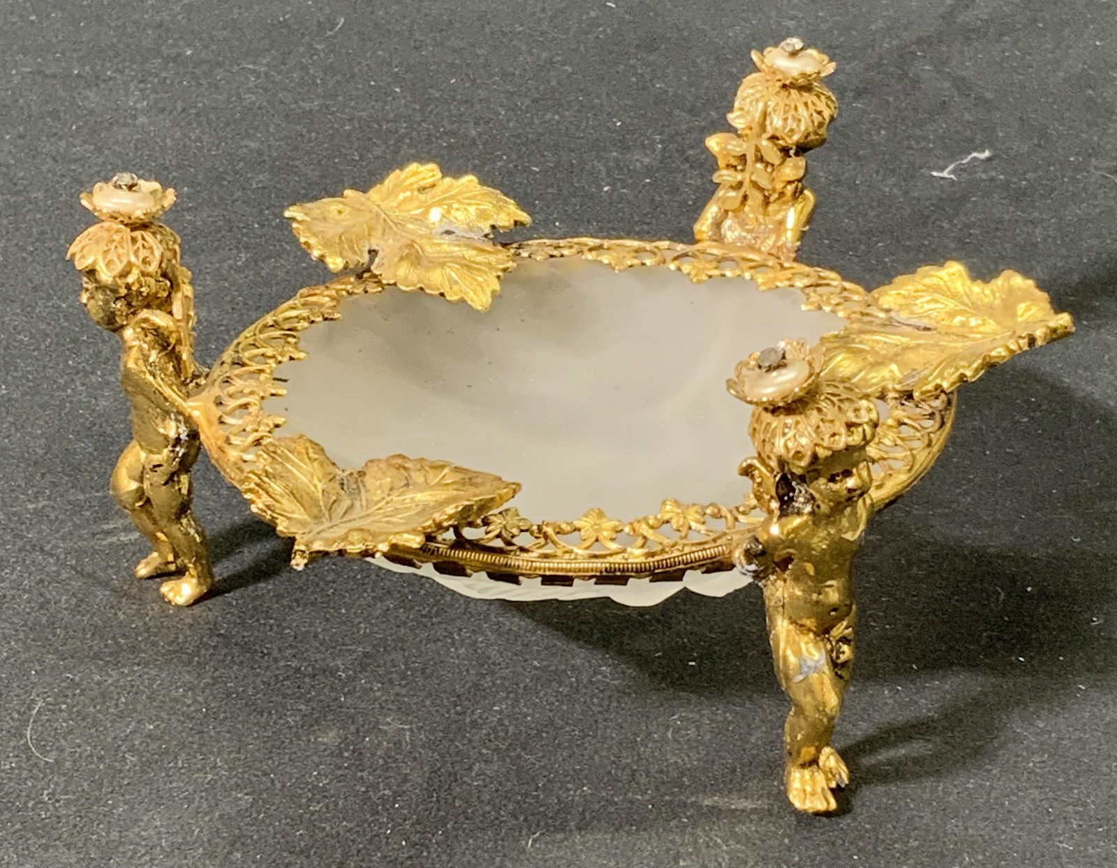 Vintage Figural Lucite Trinket Dish: A vintage trinket dish with opaque lucite bowl with embossed bird motif and gold painted metal frame with figural motif. Some wear consistent with age, use, and exposure, loss to paint. Measures appro