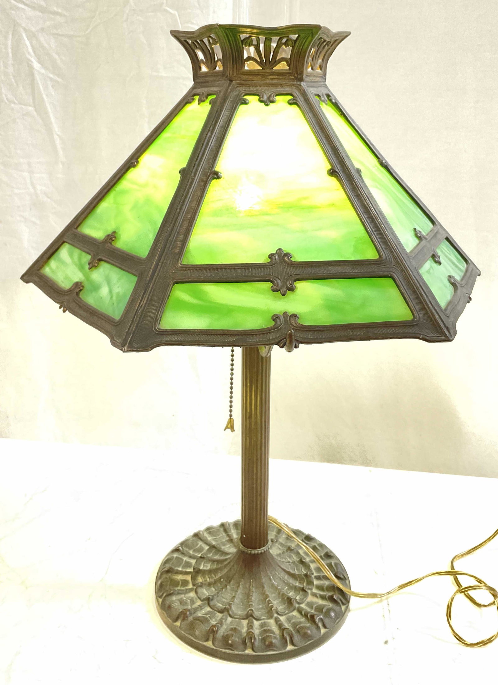 Mission Style Green Slag Table Lamp: Mission Style table lamp with Green slag glass. Insert of clear glass to inner of lamp. Measures approx 23H x 14H inches. Surface wear to metal. Lamp, table lamp, green glass, green slag glass, side t