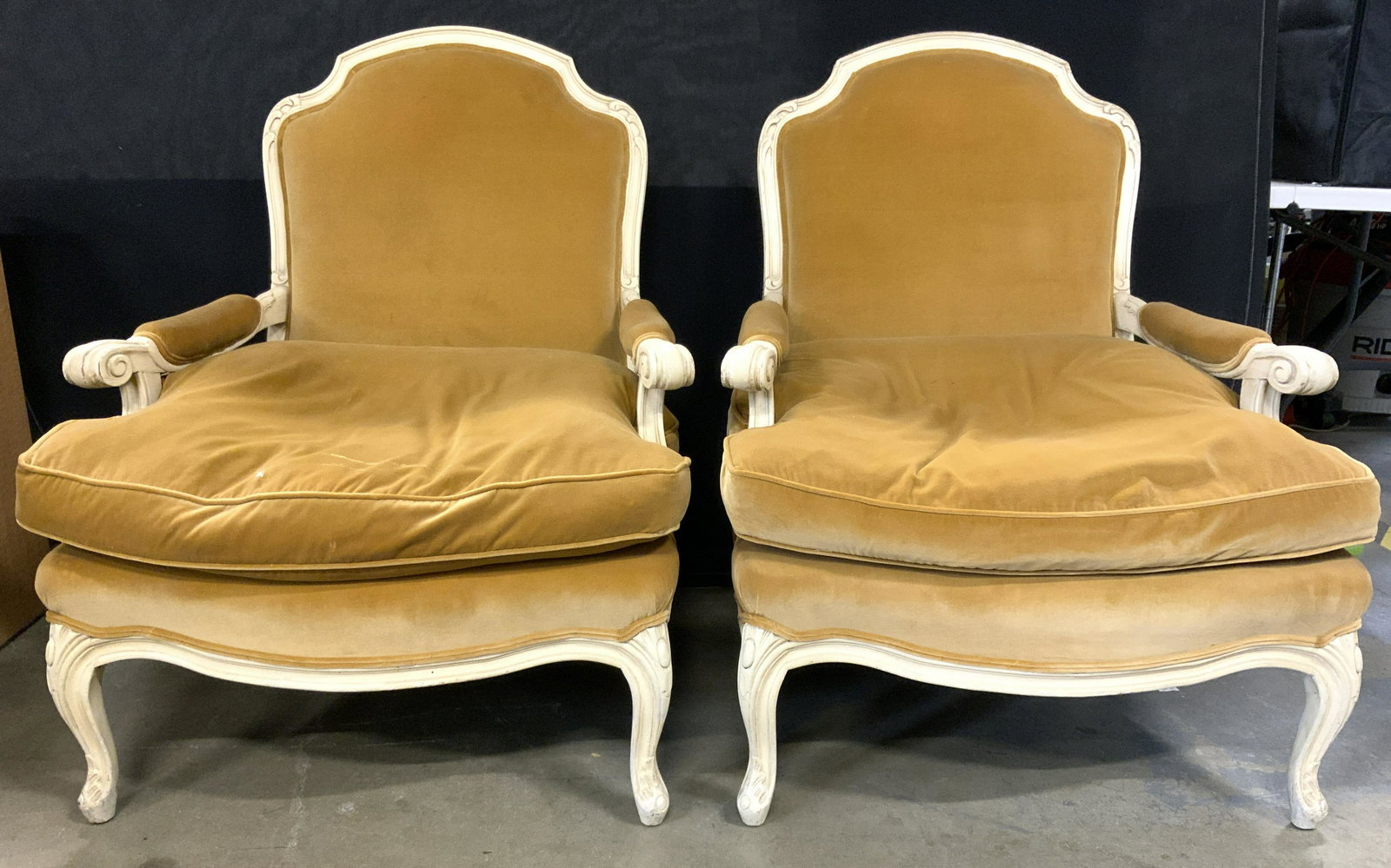 Pr Louis XV velvet Upholstered Wooden Bergeres: Lot includes 2 Bergere arm chairs. Each have carved wooden frames & copper toned velvet upholstery. Edges of upholstery have double welting. Ends of arm rests have curled structures. Each chair measur
