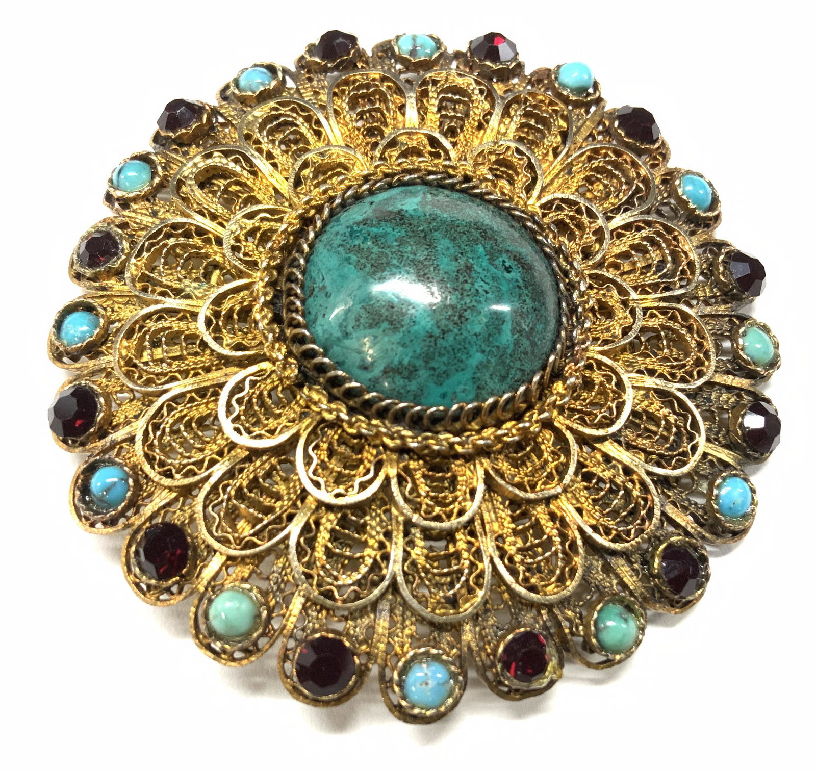 Sterling Silver Vermeil Filagree Brooch, Israel: Israel. This piece is a vintage Vermeil over sterling silver brooch, marked 925 on verso and marked Israel. Center costume Turquoise with alternating turquoise and Ruby rhinestone stones. 2 in. Brooch