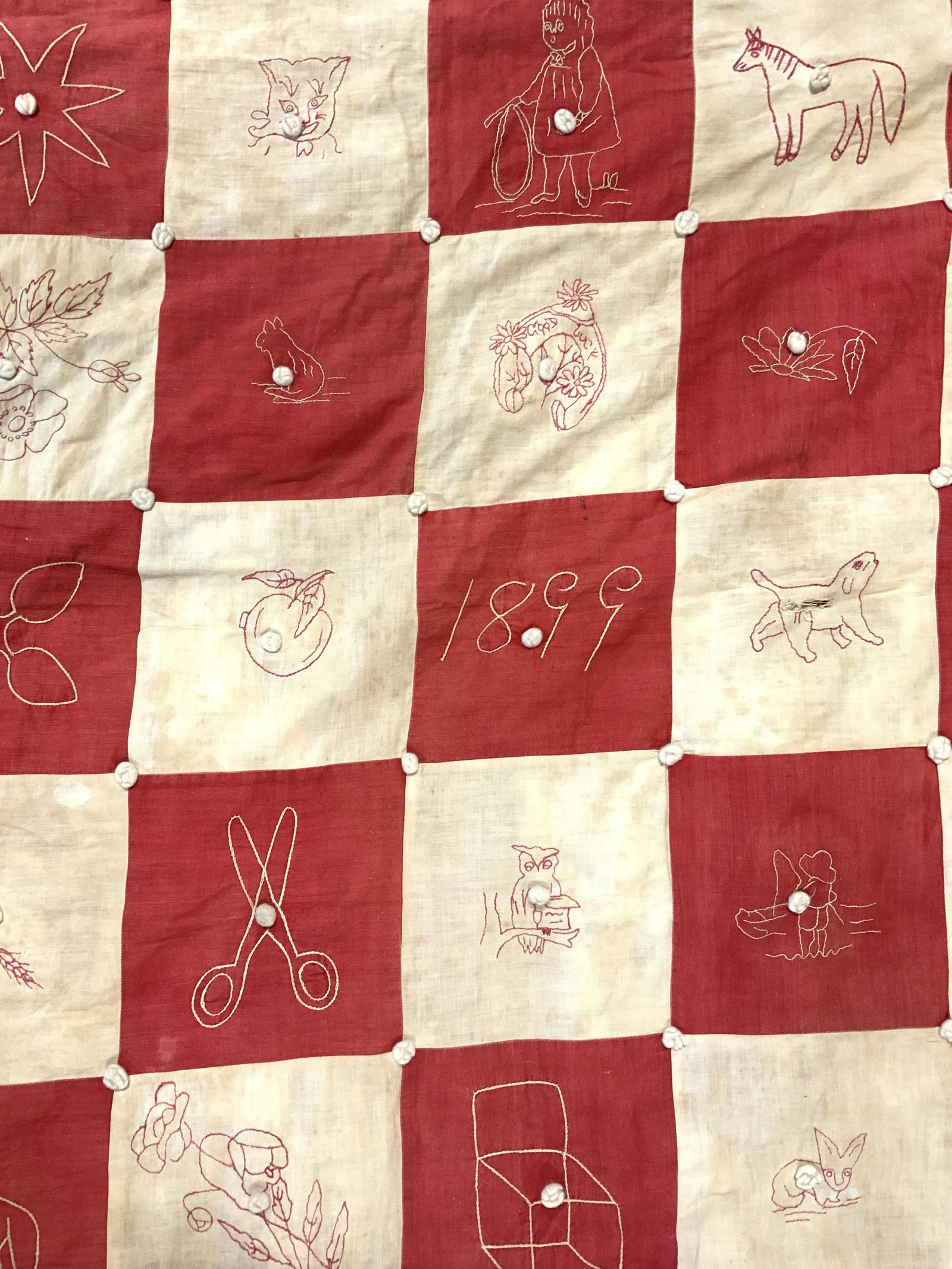 Antique Child Size Quilt W Stitch Detail: Quilt is antique. Piece is red and tan toned. Quilt has various stitched shapes such as scissors, horses, pitchers & more. Quilt has evident wear & tear 40.5 inches long 34 inches wide. Quilt, antique