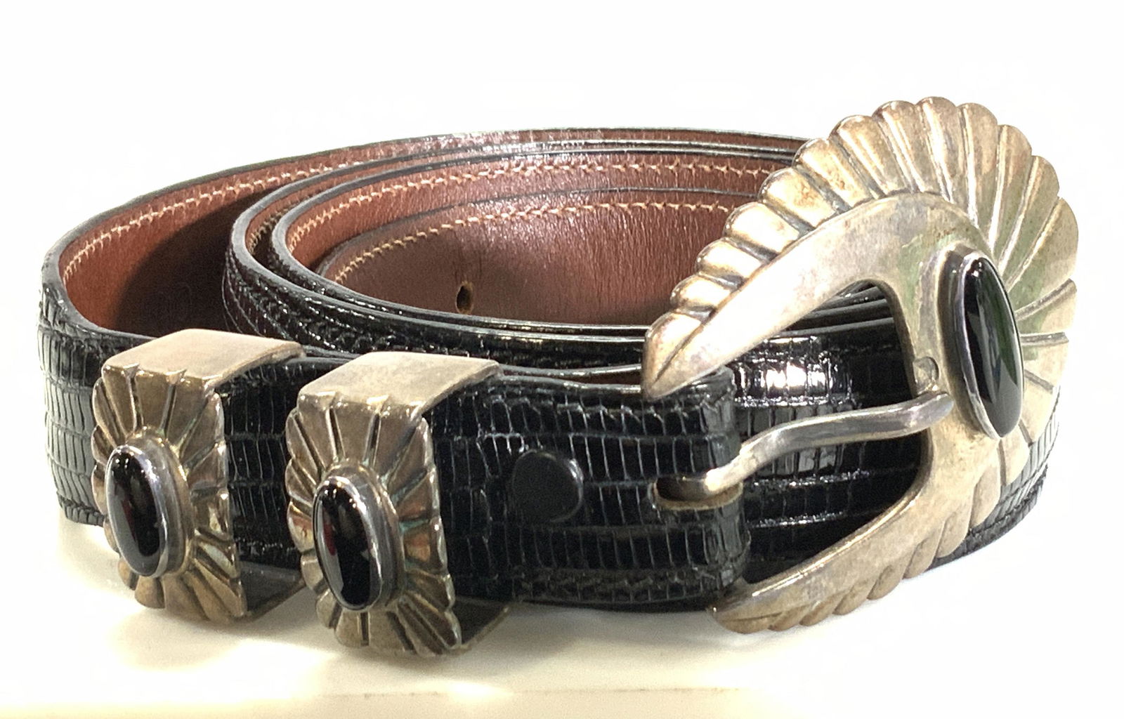 Alexanders Sterling & Lizard Buckle Belt w Bag: Genuine Lizard leather belt with sterling silver belt buckle and onyx stone. Size 40. Prongs are every one inch. Belt 1 3/16 in. Wide. Sterling weighs App 3.18 ozt. Comes in a black felt duster bag ma