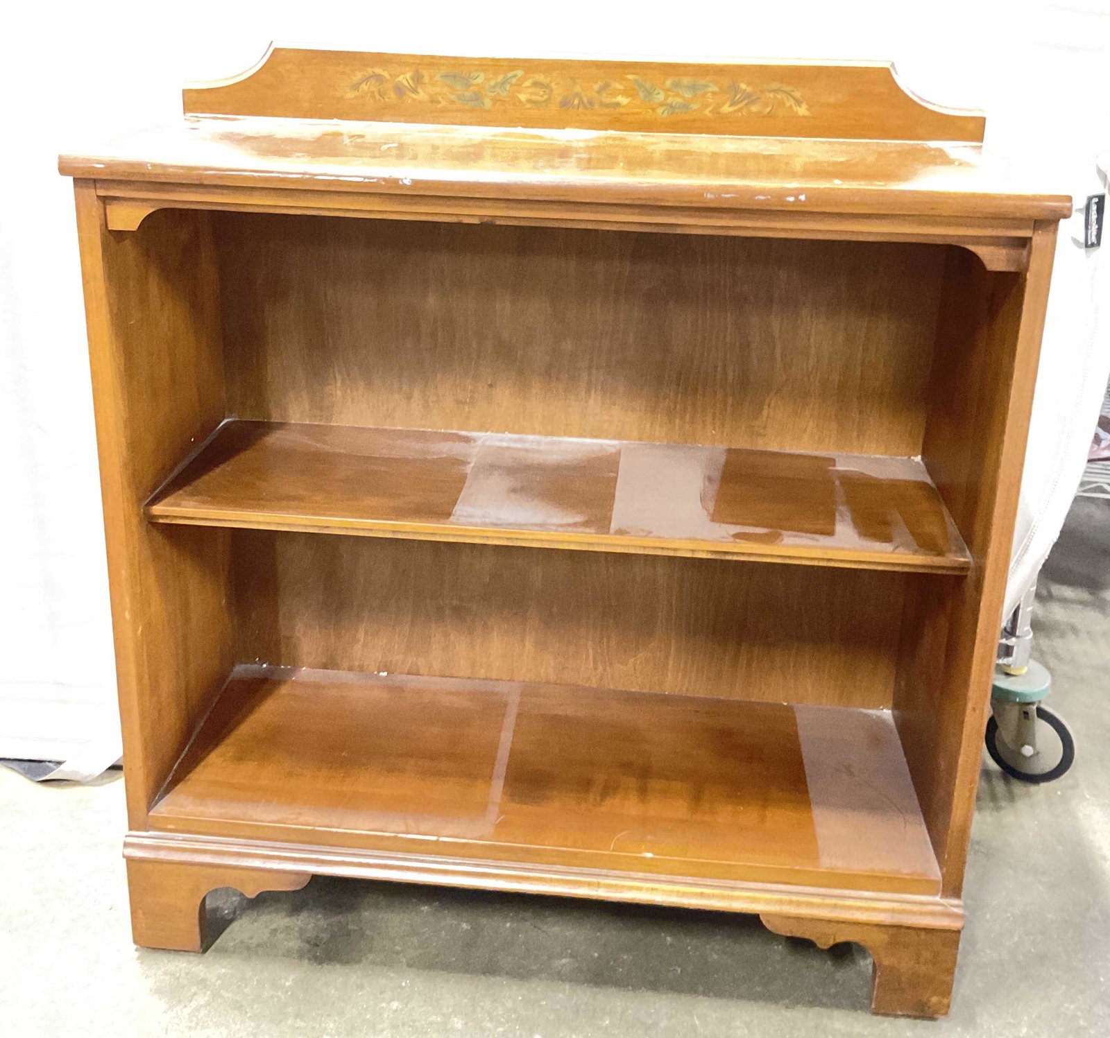 Wooden Bookshelf W Hand Painted Floral Detail: Wooden Bookshelf W Hand Painted Floral Detail To top. Measures approx 33H x 30.25W x 11D inches. Surface wear to piece consistent with age and use of piece. Some scratches to surface. Bookshelf, small