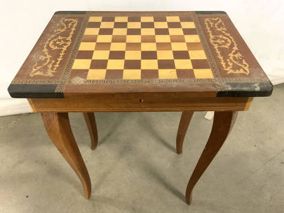 Vtg Inlaid Chessboard Top Music Box Side Table: Side table is wooden with inlaid marquetry, parquetry detail. Top has chessboard area. Table top is lidded with storage area. Piece measures approx 16.5 inches tall 14.5 inches wide 11 inches deep. Si