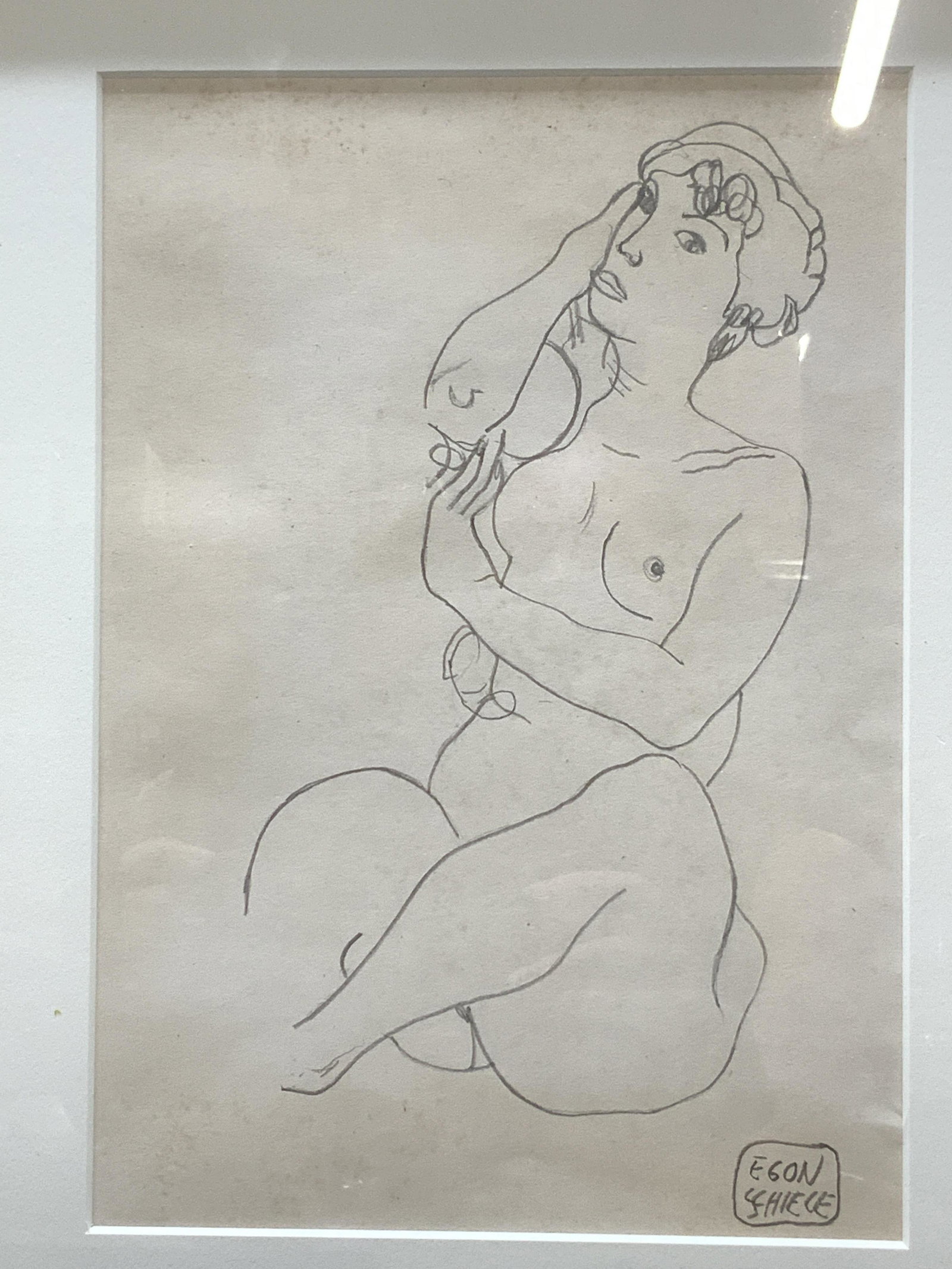 ATTR EGON SCHIELE Graphite Drawing: ATTR EGON SCHIELE Graphite Drawing, signed â€˜EGON SCHIELEâ€™ in lower right, subject shows a seated nude woman, in frame measures approx 15 3/4 x 12 3/4 in., gold toned wood frame, surface w
