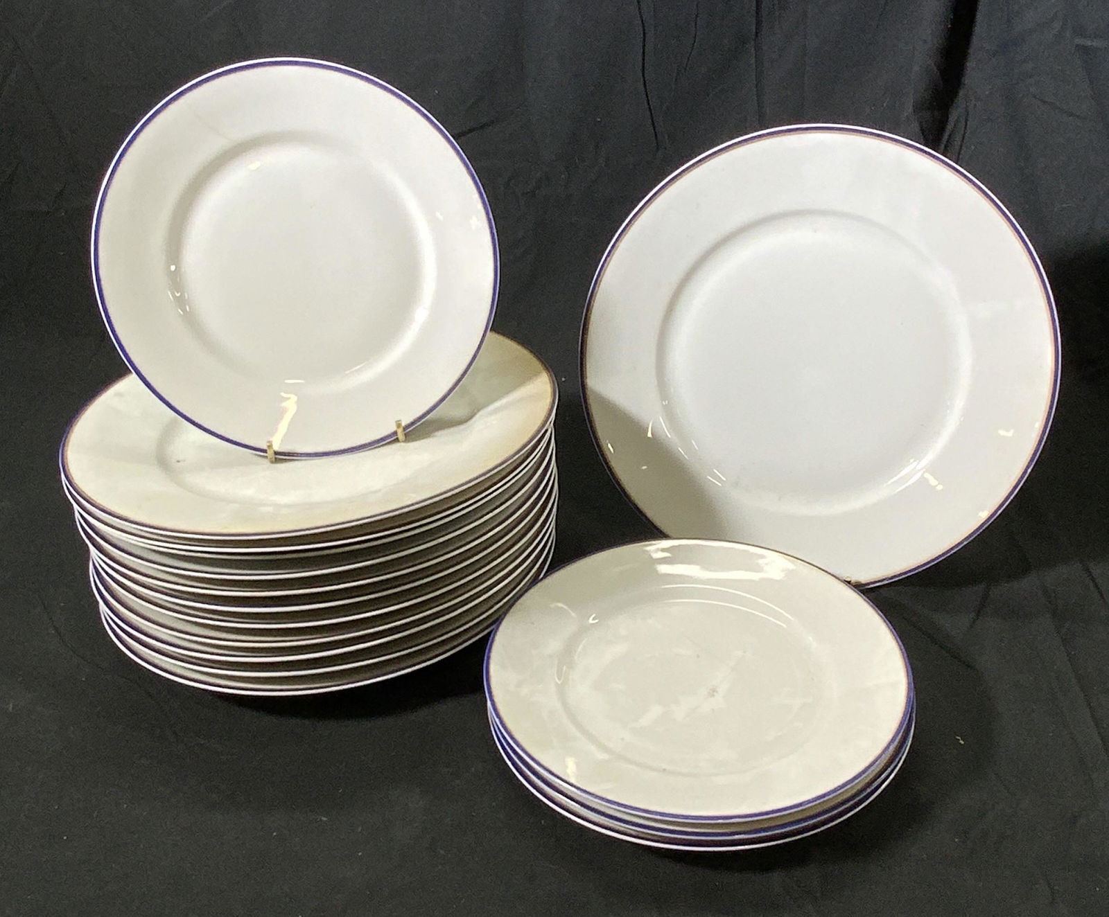 Set 16 HUTSCHENREUTHER Vintage Porcelain Plates: Hutschenreuther porcelain dishware set with gilded and blue rims, 16 total pieces. Includes 12 dinner plates and 4 appetizer plates. Dinner plates measure approx. 12 inches diameter. Appetizer plates