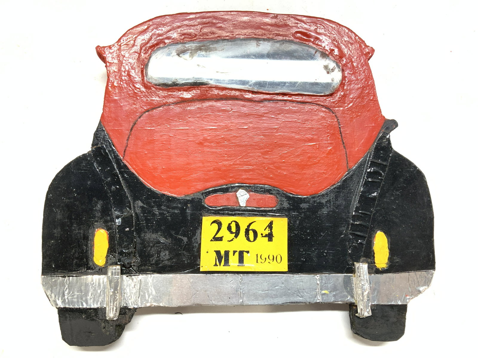 Hand Painted Wool Retro Car Wall Ornament, Sgn: Mutli Media Car form wood block, hand painted and using painted tape and tin foil. Backside of a 1940s-1950s car with license plate ‘2964 MT 1990’. Wired for hanging. measures 9.5 x 8 in. Signed o