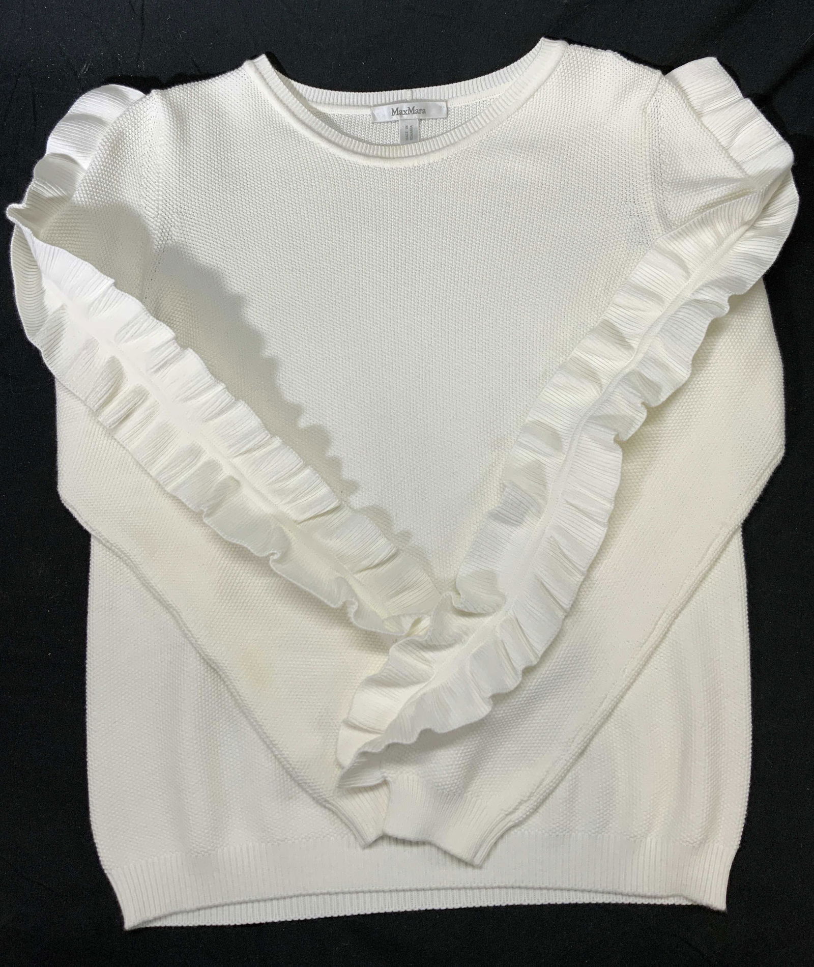 MAX MARA White Ruffle Sleeve Knit Sweater: Max Mara knit long sleeve sweater with ruffle detail to sleeve in white. No size, measures approx. 19.5 inches across chest and 24 inches shoulder to hem. Fabric has stretch. Property of Manhattan, NY