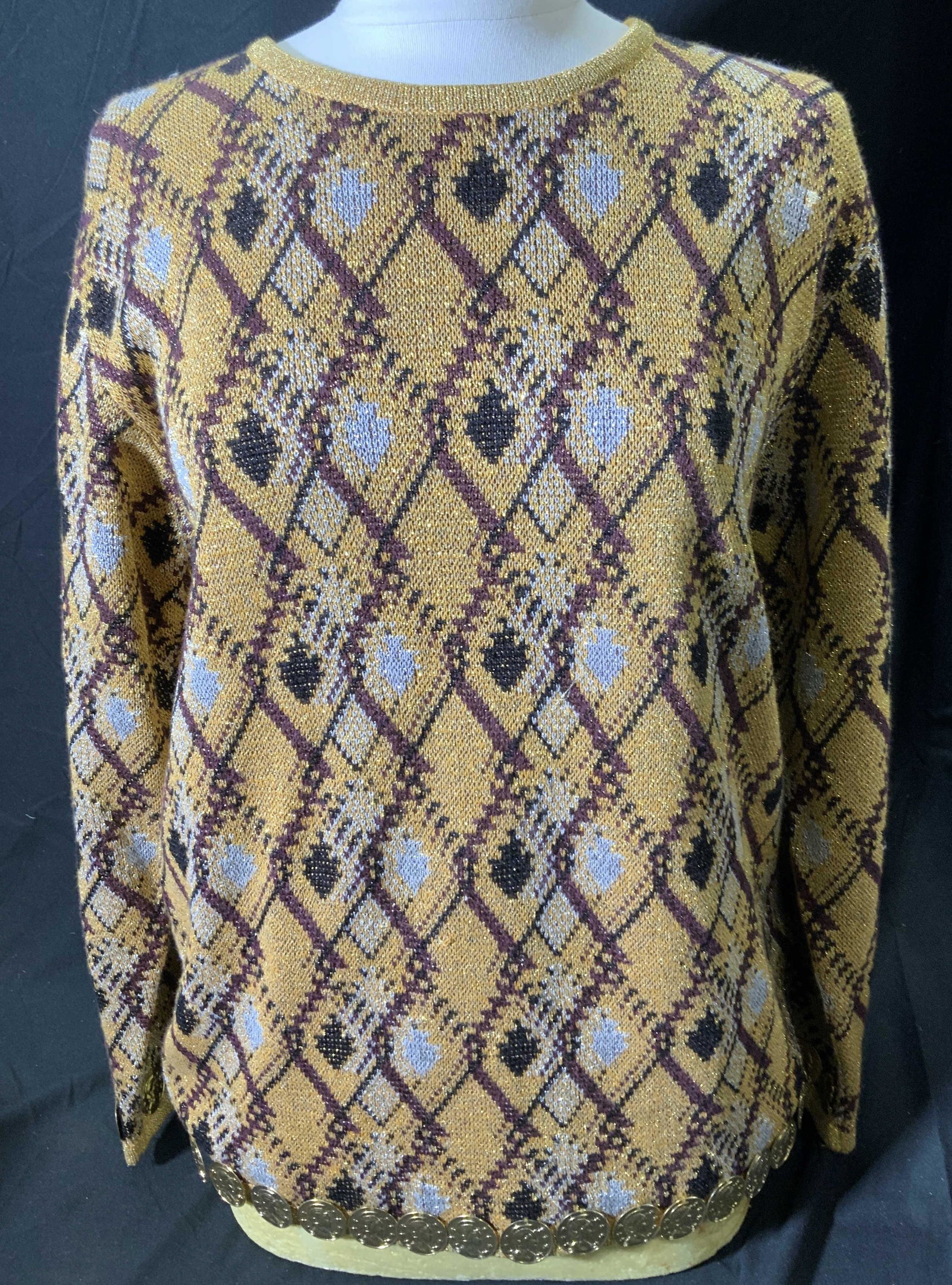 ANNE KLEIN Gold Knit Jingle Sweater: Anne Klein argyle knit sweater in hues of gold, brown, and black with gold tone jingling discs to hem. Size M. Some wear consistent with use. Anne knowing, ladies designer sweater, ladies designer kni