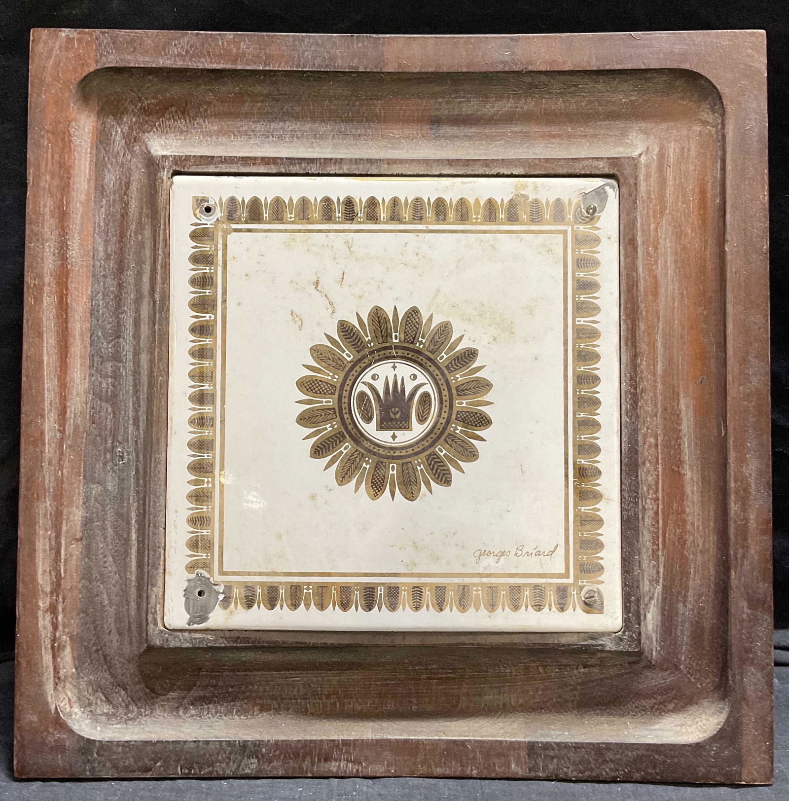 GEORGES BRIARD Enamel & Wood Trivet: GEORGES BRIARD Enamel & Wood Trivet, inscription to piece reads ‘Georges Briard’, features an enamel panel with gilt vegetal pattern, measures 13 1/2 x 13 1/2 inches, 1 1/2 inches tall. some losse