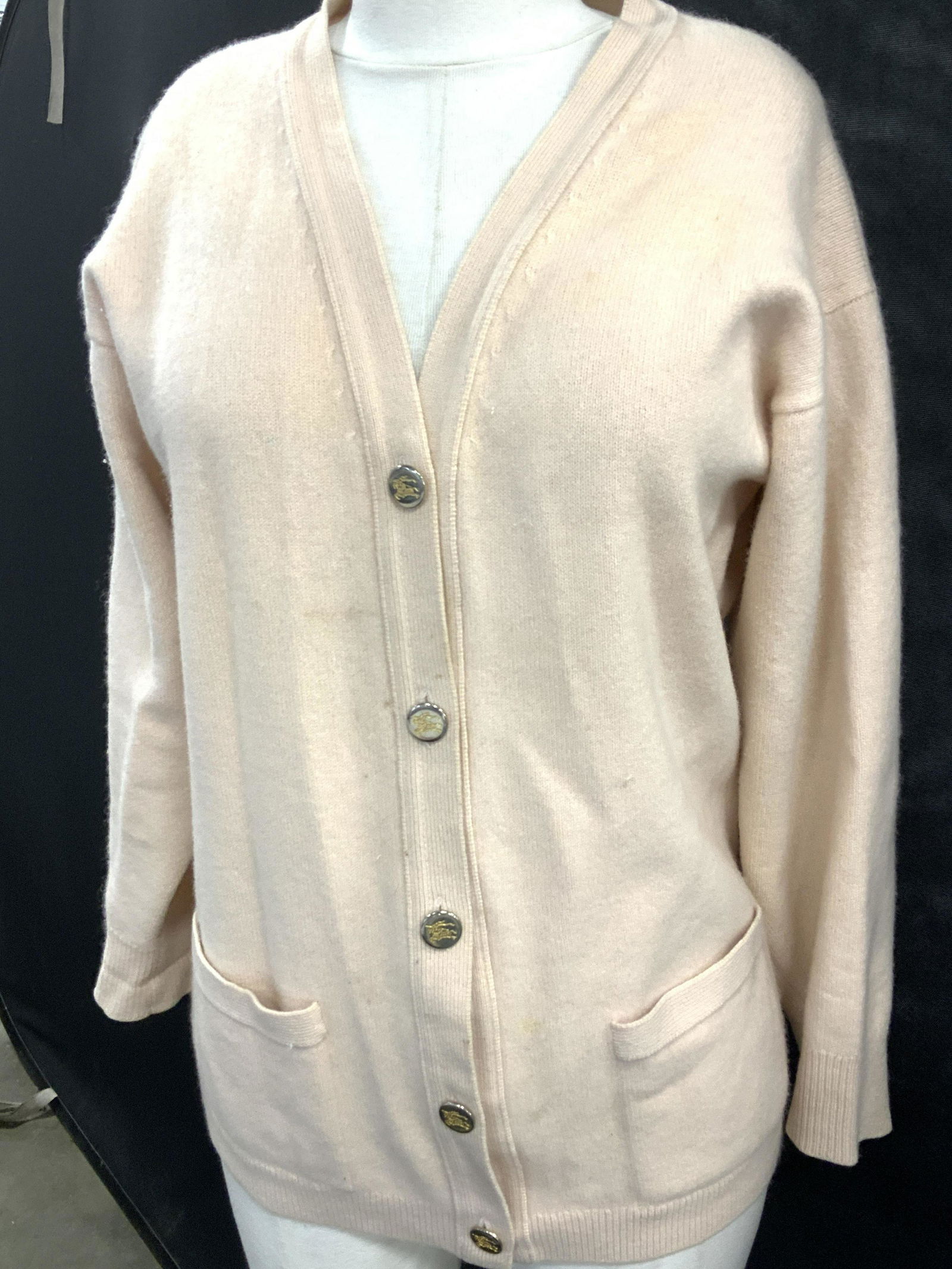BURBERRYS CASHMERE CARDIGAN, SCOTLAND: Thick blushed toned cashmere cardigan, signed label attached reads BURBERRYs LONDON New York PARIS 100% cashmere Made in Scotland Ladies size Med. Two toned Burberry Logo buttons. Vintage, well mainta