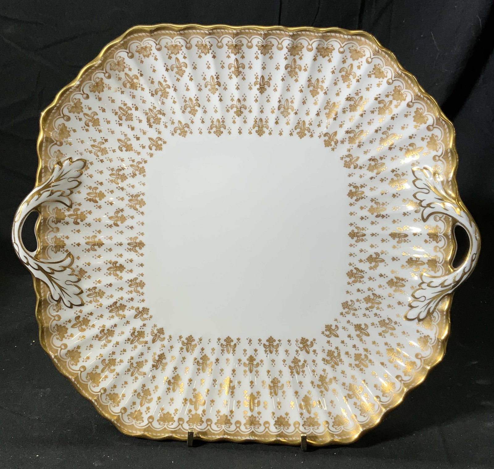 SPODE Vtg Gilt Fleur de Lys Square Platter: Vintage Spode bone china gilt serving platter with handles and fleur de lys motif. Marked SPODE to underside. Measures approx. 9.5 x 9.5 inches. Minor wear to surface consistent with exposure. Spode, 
