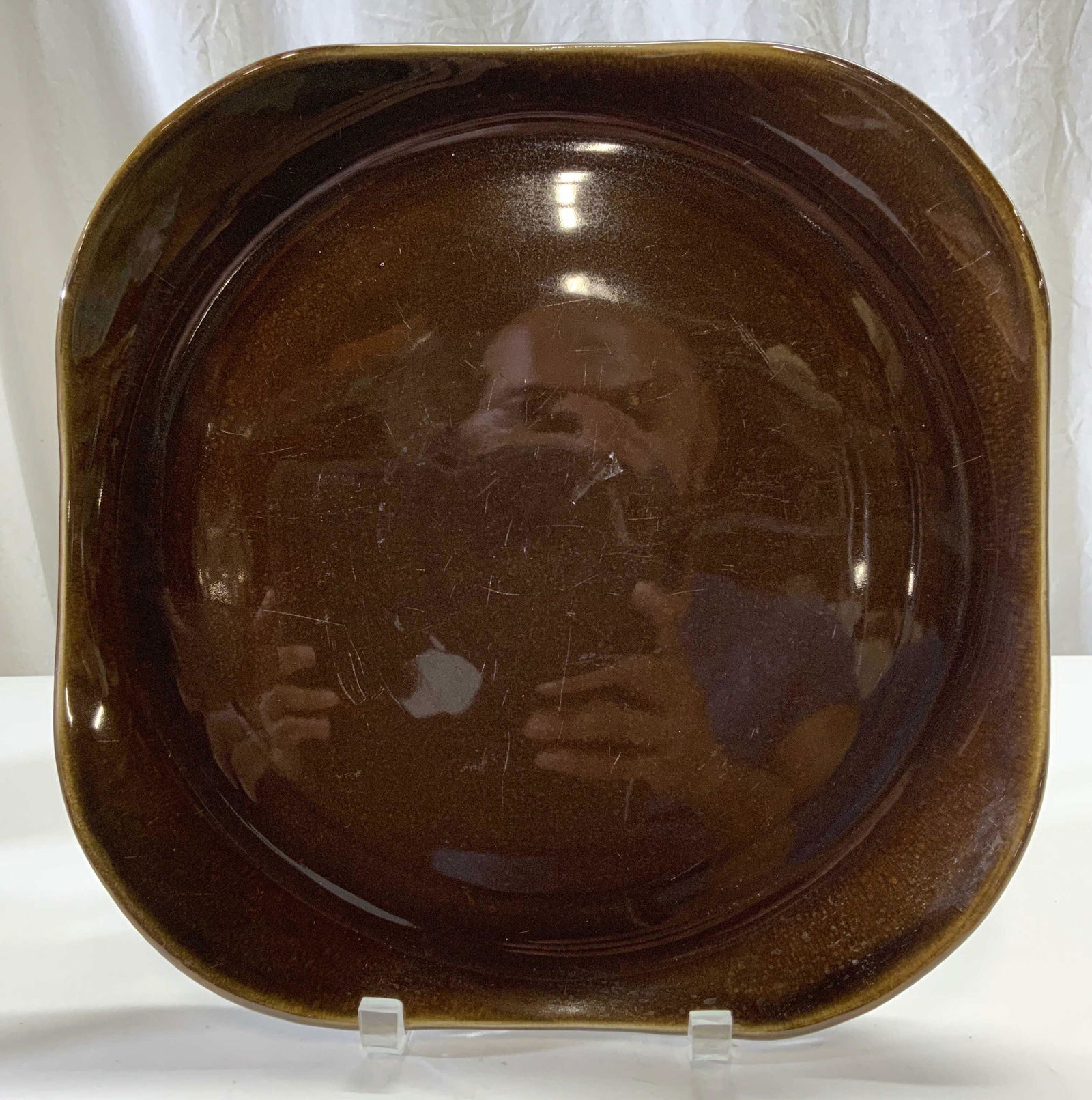 RUSSEL WRIGHT Signed Ceramic Plate: Underside is signed RESSEL WRIGHT. Plate is brown toned and ceramic. Piece has square like shape with rounded corners. Piece measures approx 13 inches wide & deep. Plate, ceramic plate, Russel Wright