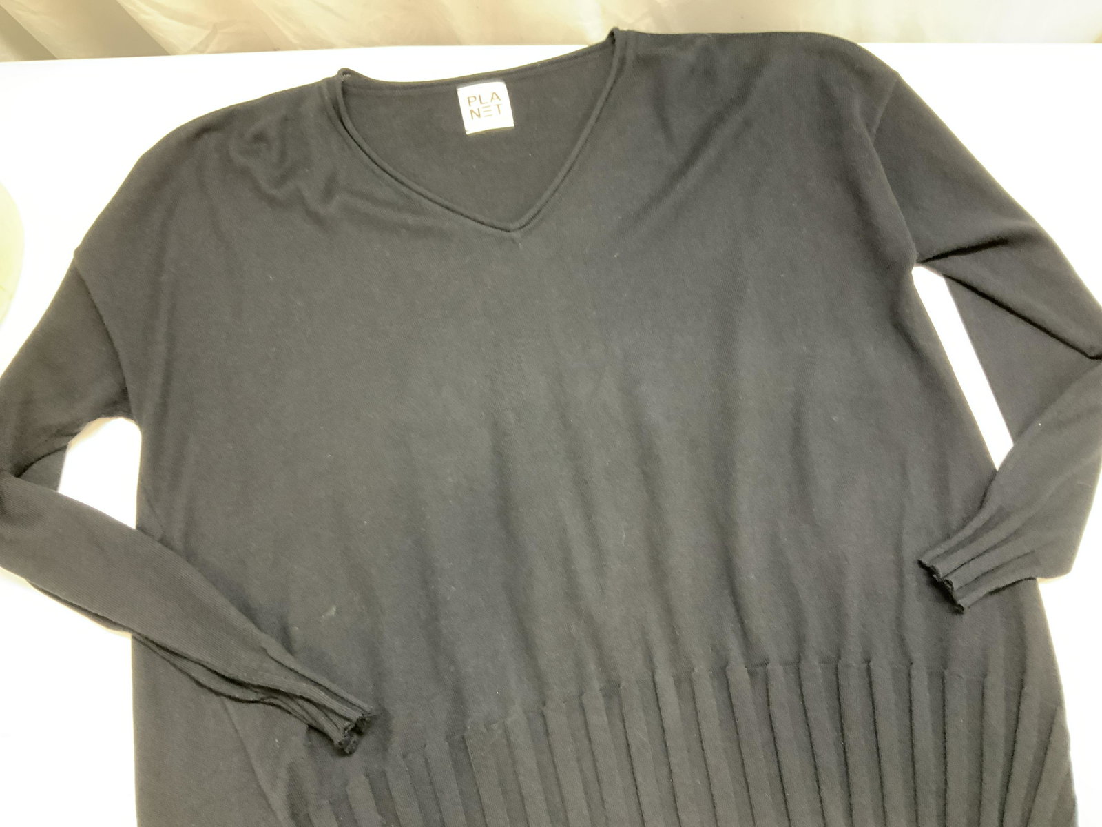 PLANET Pima Cotton Knit Sweater, one size: One size fits all black knit sweater, signed label PlaNet, slight v neck, ribbed lower hem and sleeve cuffs. Plus size to small size. Soft hand fabric 60% Pima cotton, 40% Tencel. Possibly never worn 