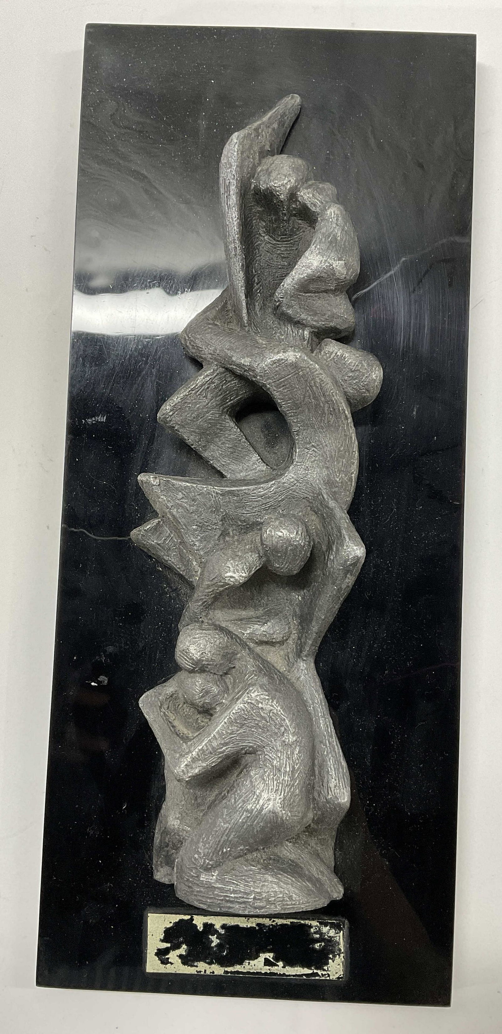 Sculpture Of People Embracing On Wall Mount: Sculpture of people embracing despair, climbing. Probably composite material. Measures approx 16.75 x 7 inches. No plaque to piece. Wire to back. Surface wear to piece consistent with age and use. 11 