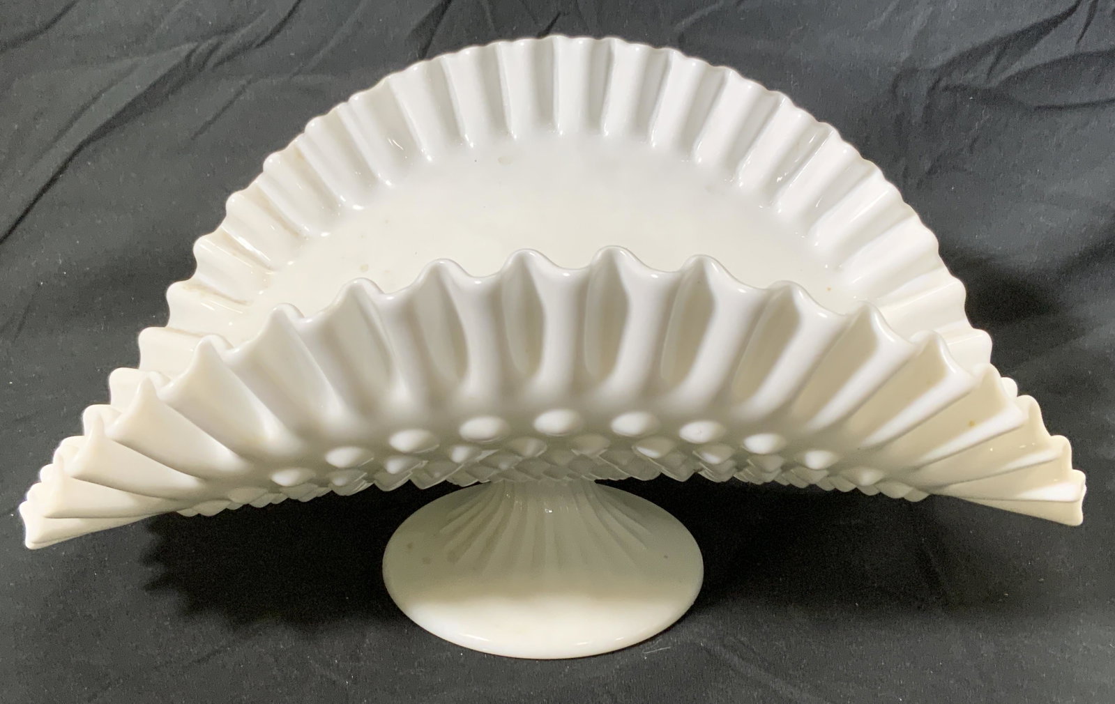 Vintage Handkerchief Milk Glass Banana Boat: Vintage milk glass banana boat with handkerchief glass rim and hobnail detail to underside. Measures approx. 12.5 x 8.75 x 6 inches. Some wear to surface consistent with age and exposure. Milk glass, 