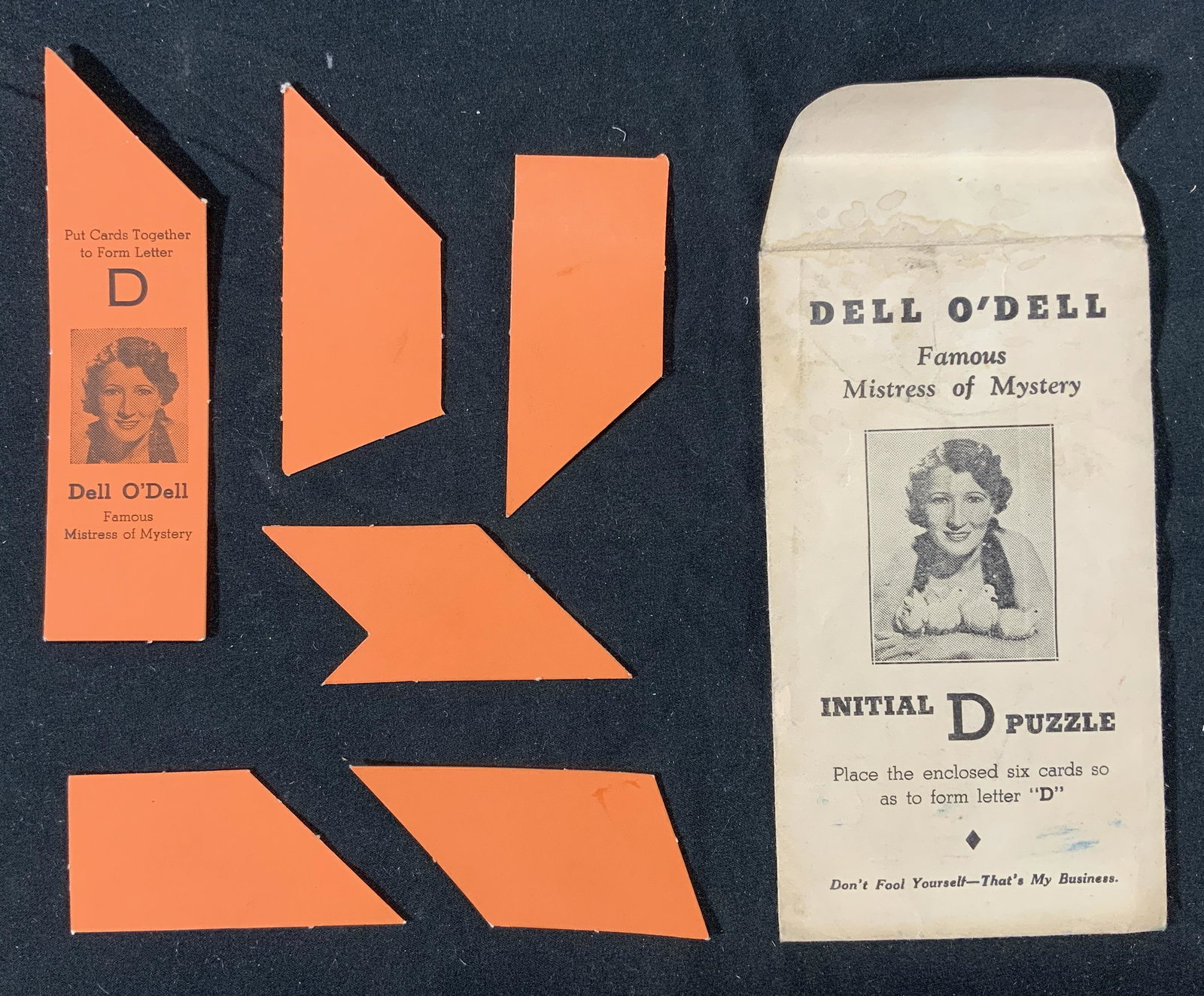 Vintage DELL O DELL Initial D Puzzle: Vintage Dell O Dell initial D puzzle in original package. Contains 6 cards to be arranged to form the letter D. Package measures approx. 5.5 x 3 inches. Wear consistent with age and exposure. Vintage 