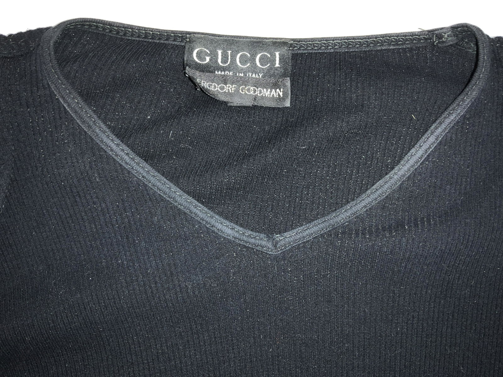 GUCCI STRECH KNIT SHORT SLEEVE TOP, IT: Black cotton knitwear, signed GUCCI, Bergdorf Goodman, and Made in Italy, size large, vintage top with shoulder pads. Property of Manhattan, NY Estate 3 Ladies tops, designer Gucci, Ladies luxury casu