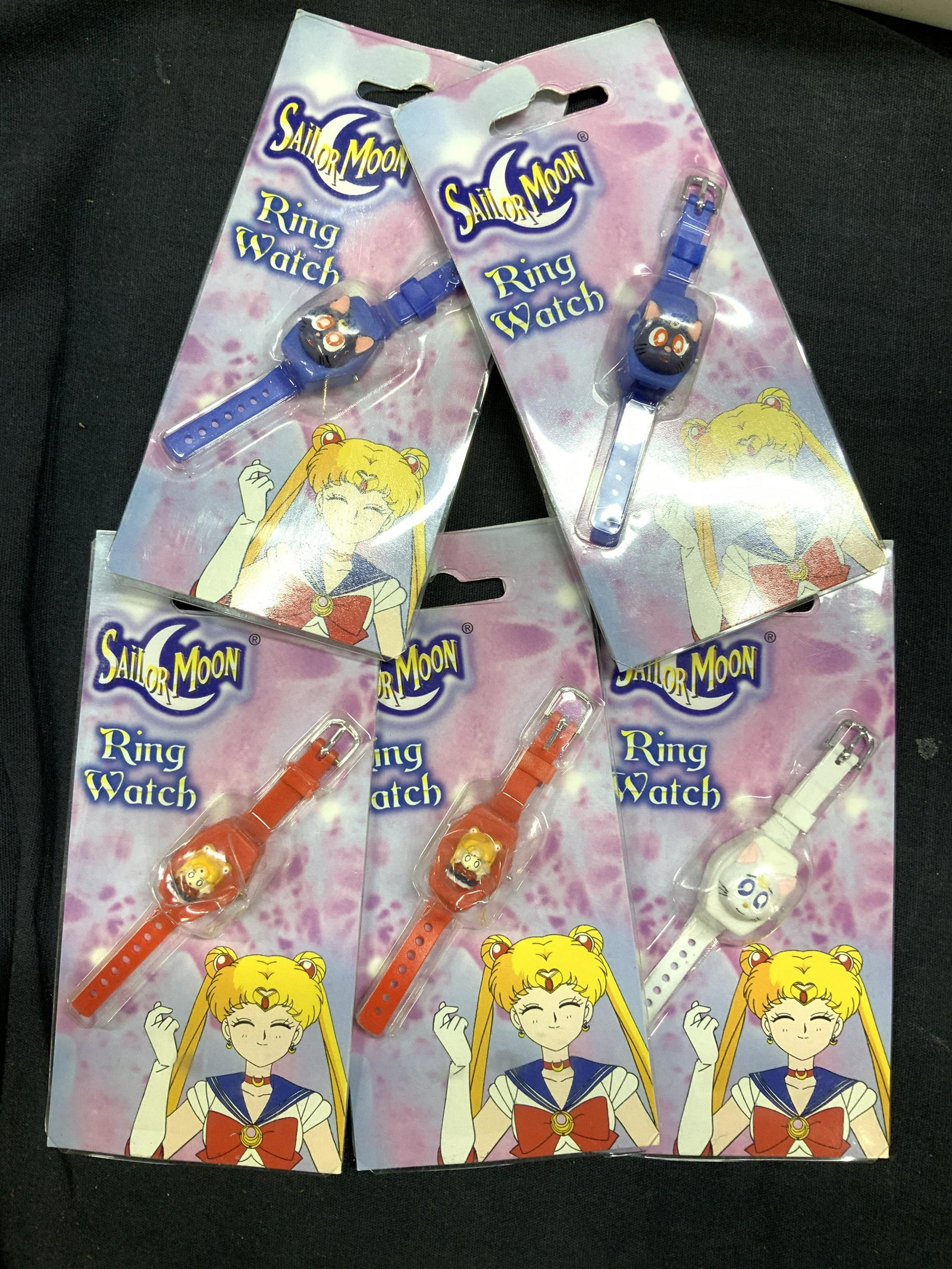 Set 5 SAILOR MOON Ring Watches, Urban Station NIP: Ring watches for kids with Character of cartoon and comic strip Sailor Moon. new old stock in original packaging, un opened. Red , blue and white kid’s fashion jewelry. shows date and month and seco