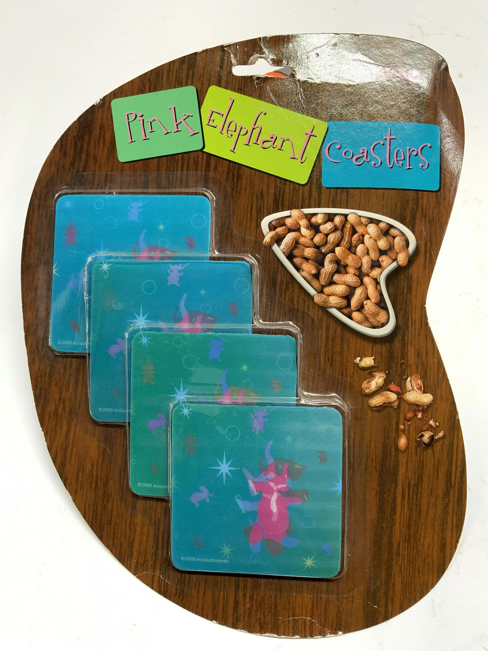 ACCOUTREMENTS Holographic Elephant Coasters NiP: Packaging reads PINK ELEPHANT COASTERS. Coasters read copyright 2000 Accoutrements. Coasters appear to be holographic. Packaging measures approx 12.5 inches tall 10 inches wide. Coasters, elephant coa